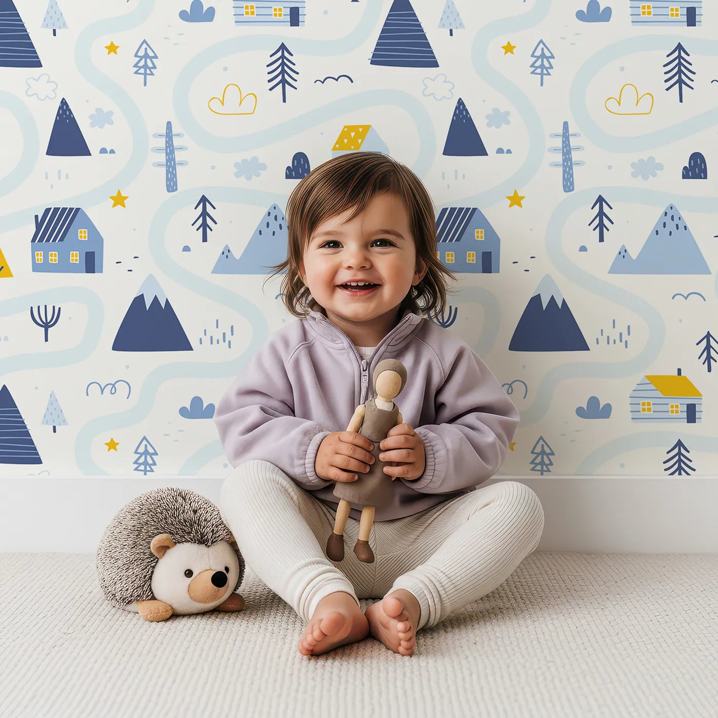 Lovely child standing in front of Whimsy Tots Winter Village Map Wallpaper with winter, village, map, house, mountain in design.