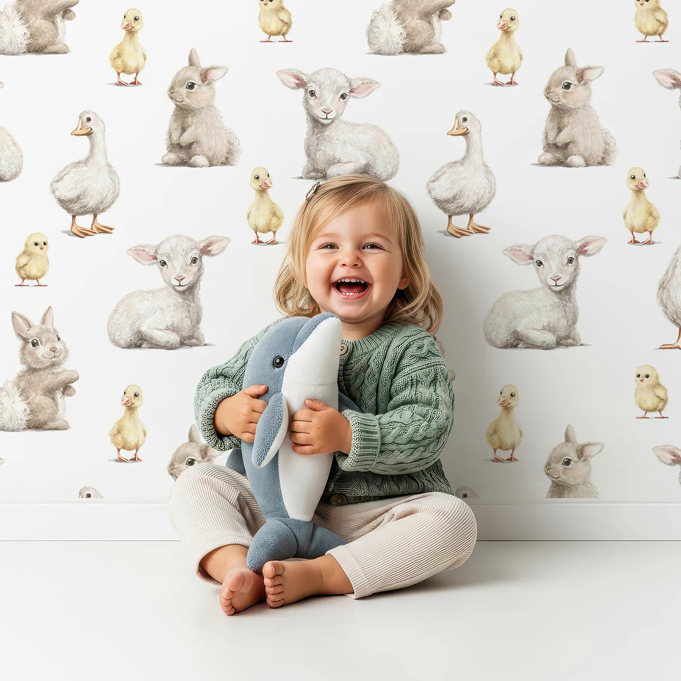 Lovely child standing in front of Whimsy Tots Realistic Baby Farm Animals Wallpaper with farm, animal, baby, realistic, lamb in design.