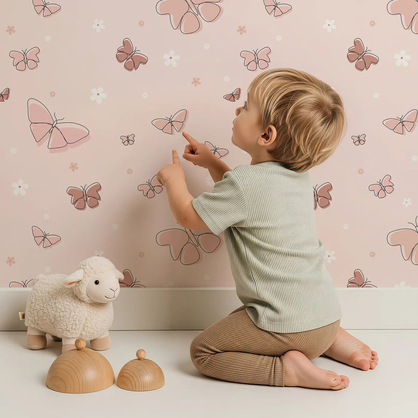 Lovely child standing in front of Whimsy Tots Minimalist Butterfly Garden Wallpaper in Rose gold with butterfly, flower, minimalist, pink, line art in design.