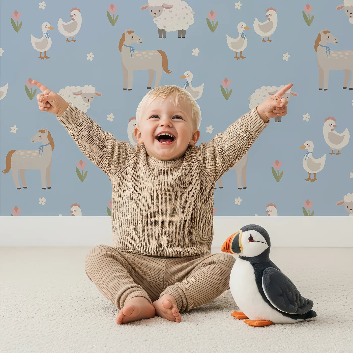 Lovely child standing in front of Whimsy Tots Gentle Farm Friends Wallpaper in Blue with farm, animal, horse, sheep, duck in design.