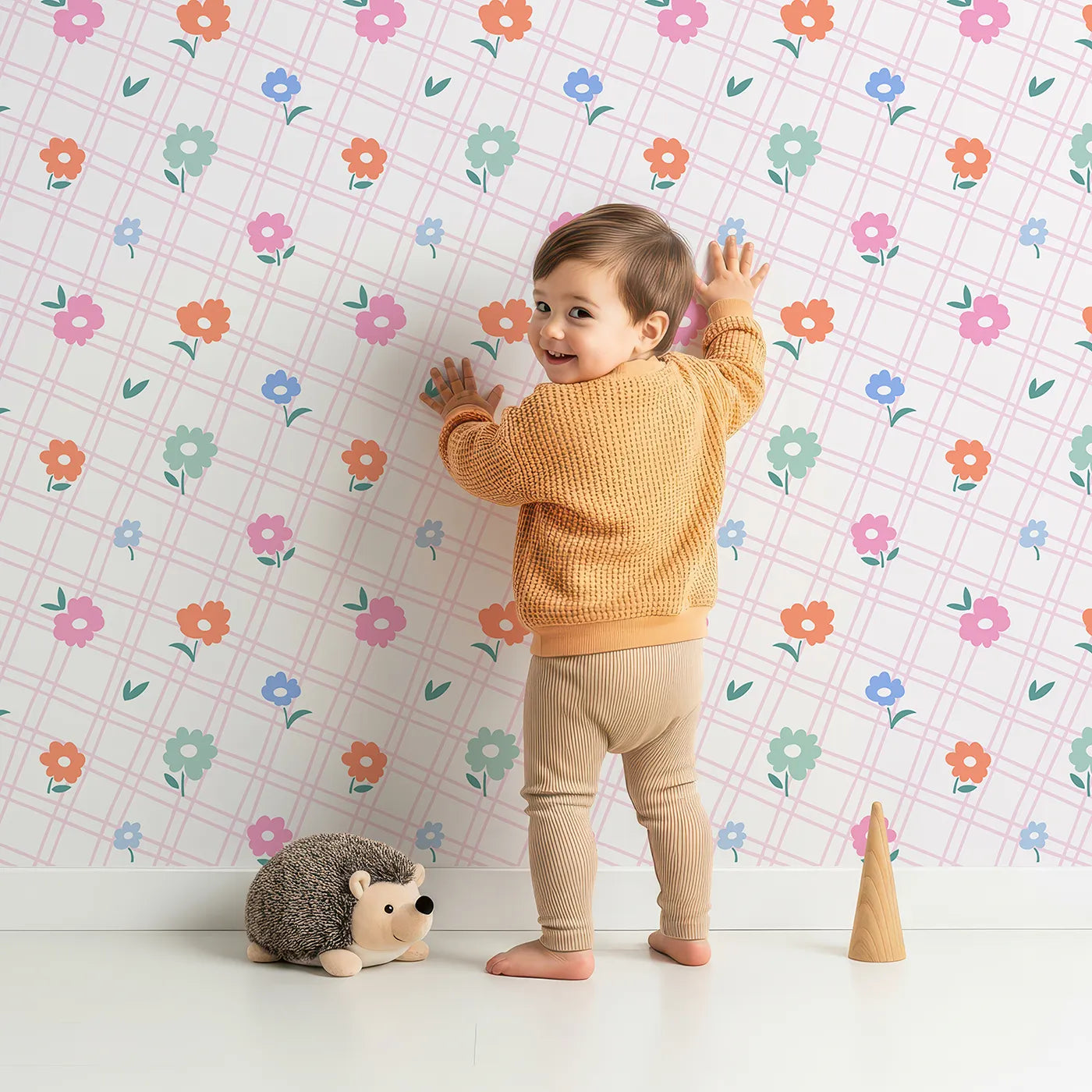 Lovely child standing in front of Whimsy Tots Plaid Garden Flowers Wallpaper with flower, plaid, grid, pink, colorful in design.