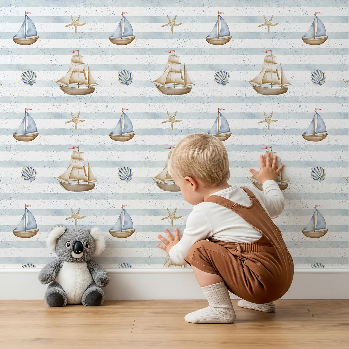 Lovely child standing in front of Whimsy Tots Vintage Sailboat Stripes Wallpaper with boat, ship, sailboat, sea, stripe in design.