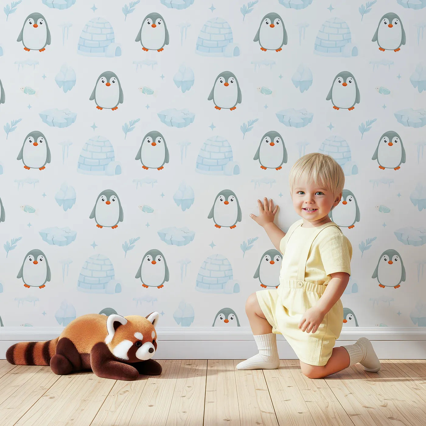 Lovely child standing in front of Whimsy Tots Arctic Penguin Playground Wallpaper with penguin, igloo, arctic, snow, winter in design.