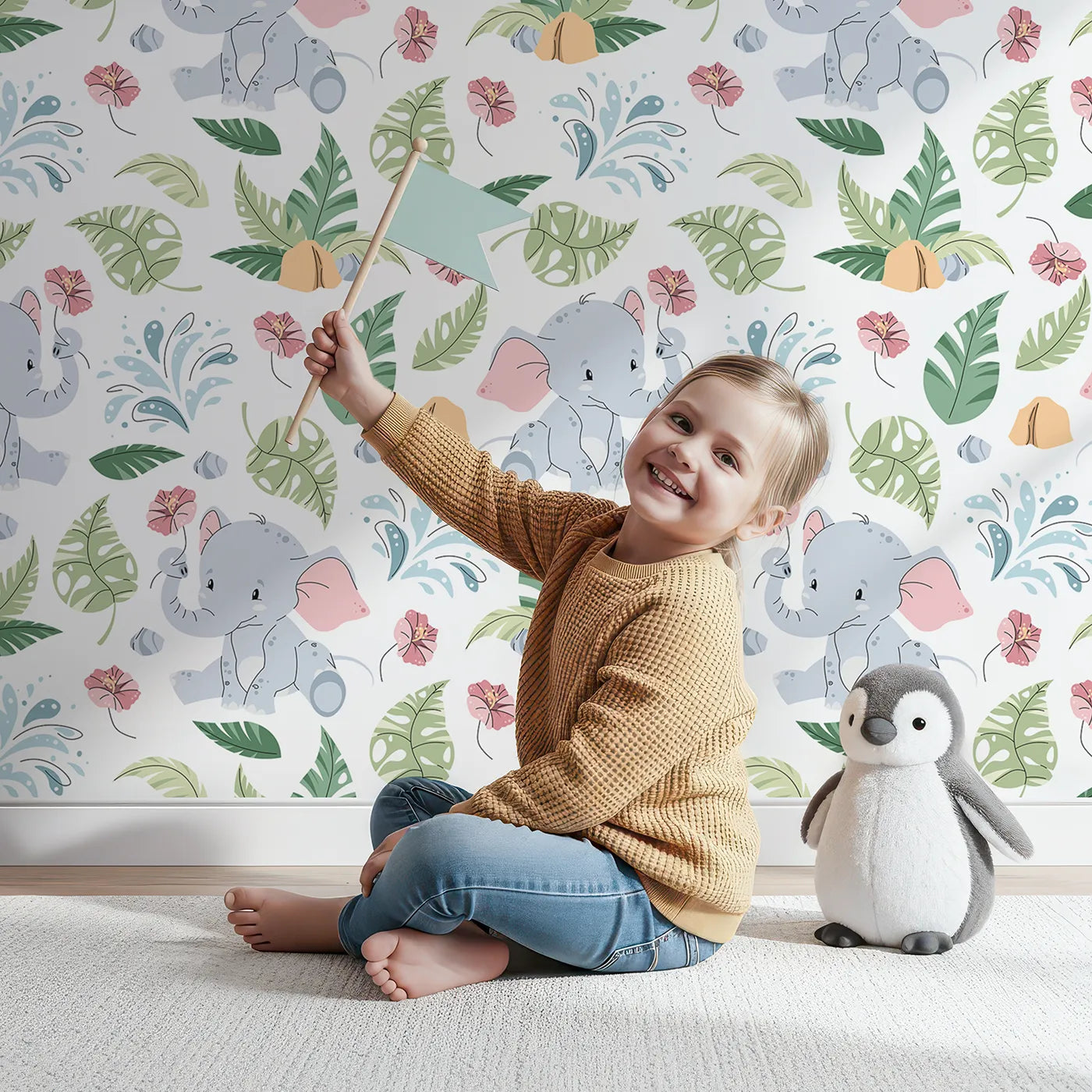 Lovely child standing in front of Whimsy Tots Baby Elephant Splash Wallpaper with elephant, baby, tropical, leaf, flower in design.