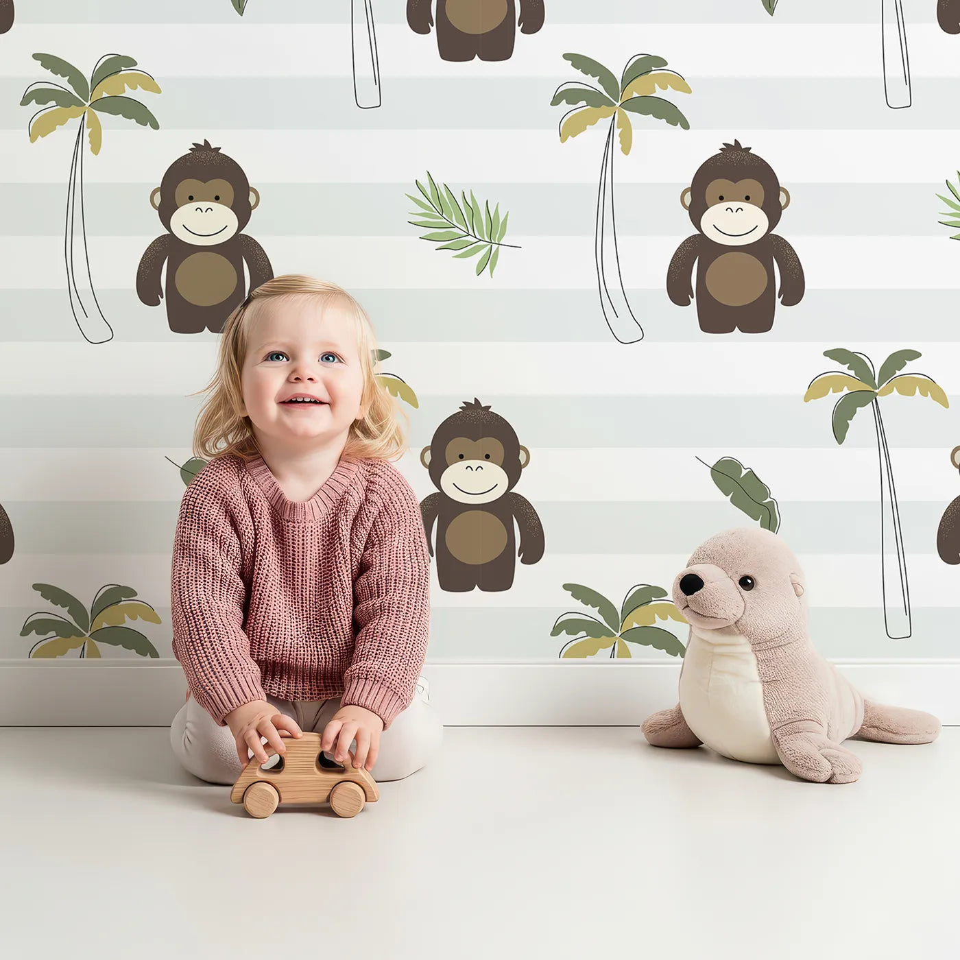 Lovely child standing in front of Whimsy Tots Striped Monkey Jungle Wallpaper with monkey, palm tree, tropical, jungle, stripe in design.