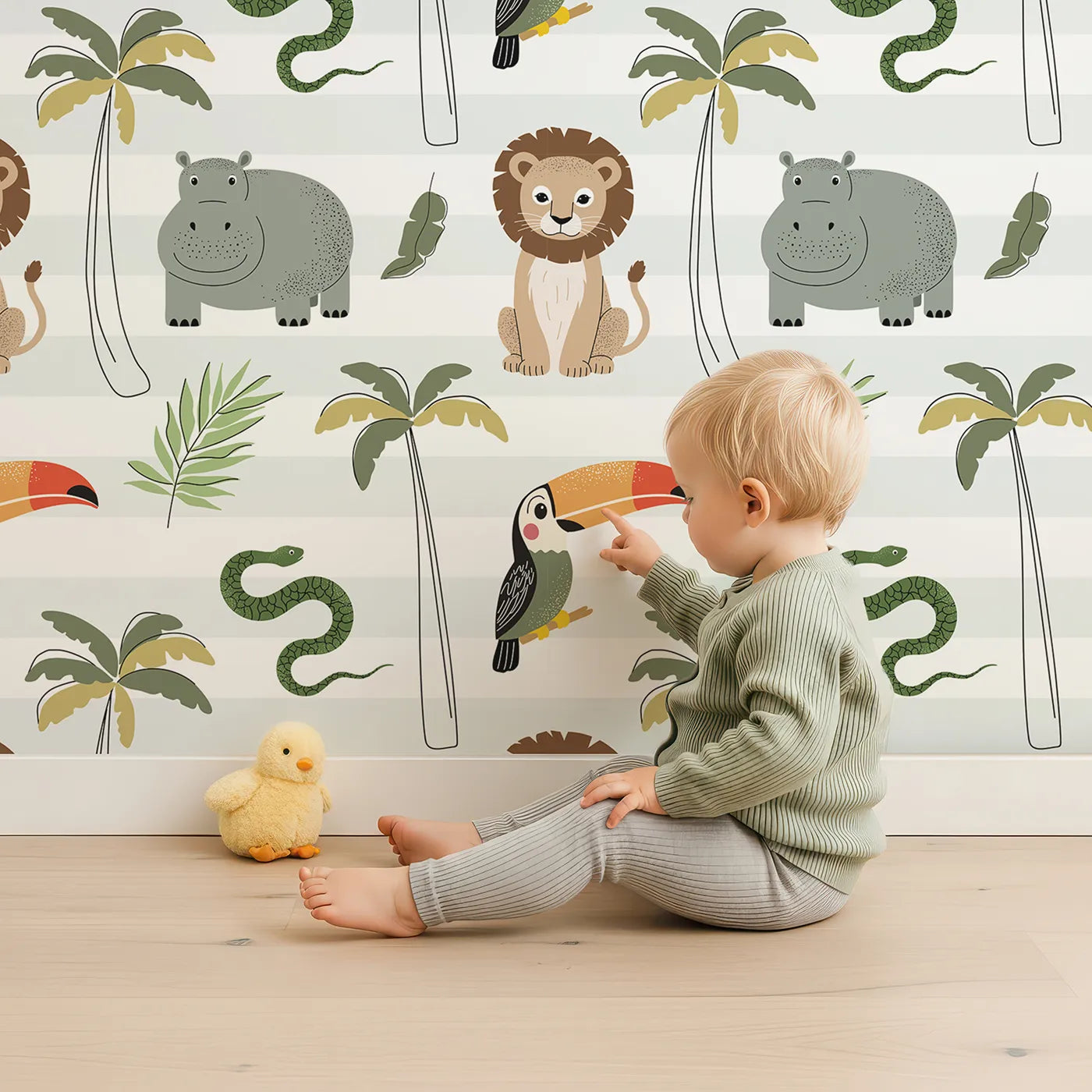 Lovely child standing in front of Whimsy Tots Striped Safari Friends Wallpaper with safari, lion, hippo, toucan, palm tree in design.