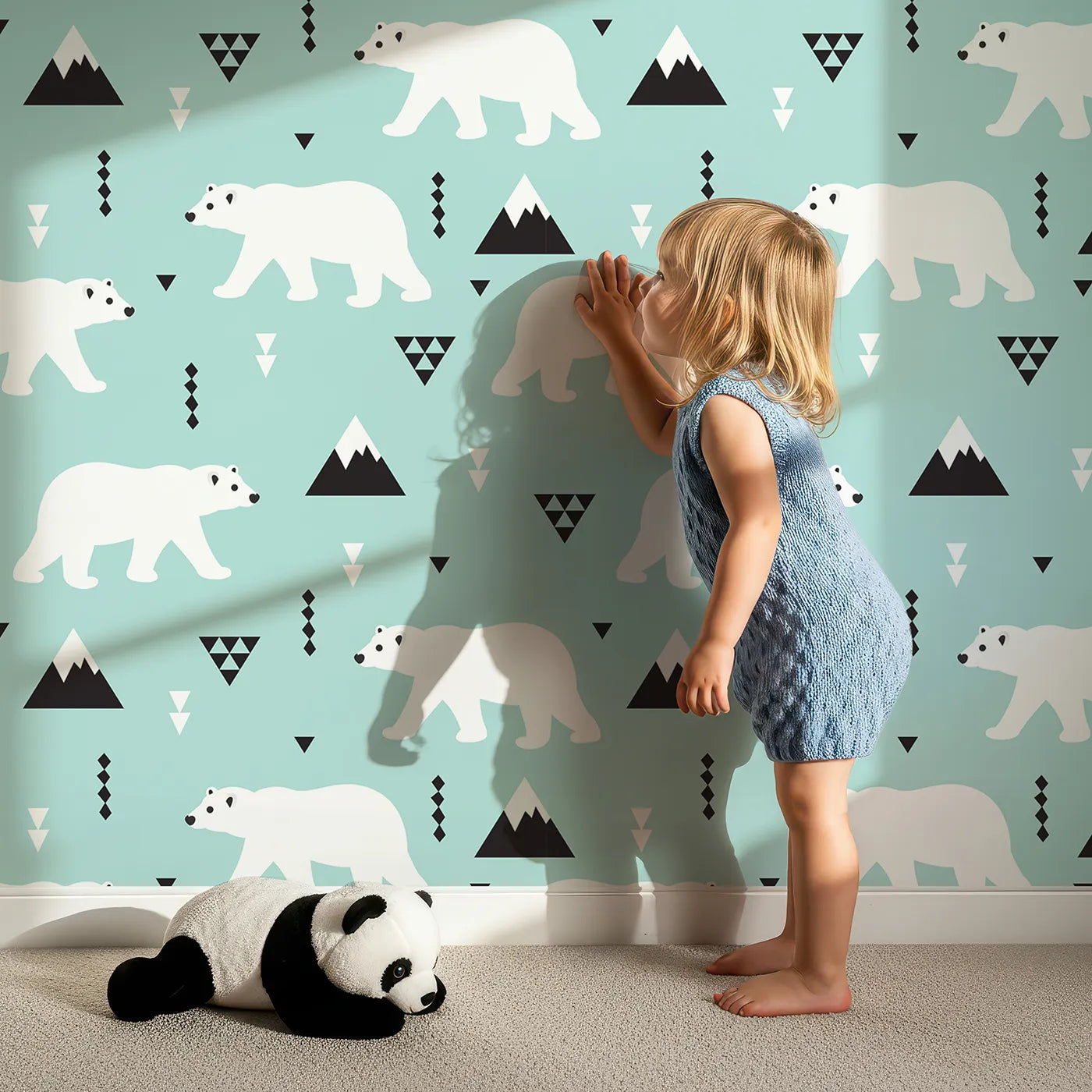 Lovely child standing in front of Whimsy Tots Geometric Polar Bear Mountains Wallpaper with polar bear, mountain, geometric, modern, arctic in design.