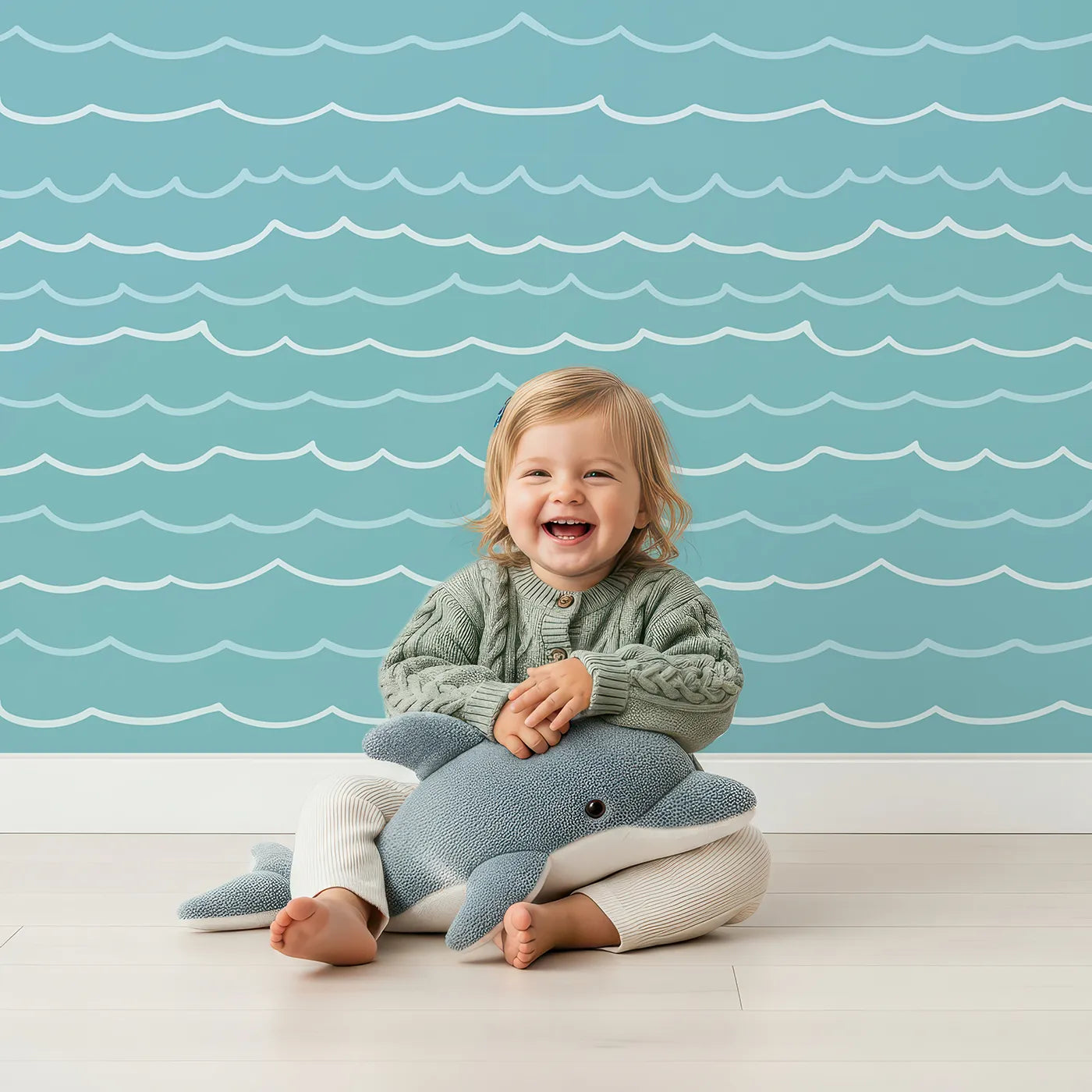 Lovely child standing in front of Whimsy Tots Simple Ocean Waves Wallpaper with wave, ocean, sea, minimalist, blue in design.