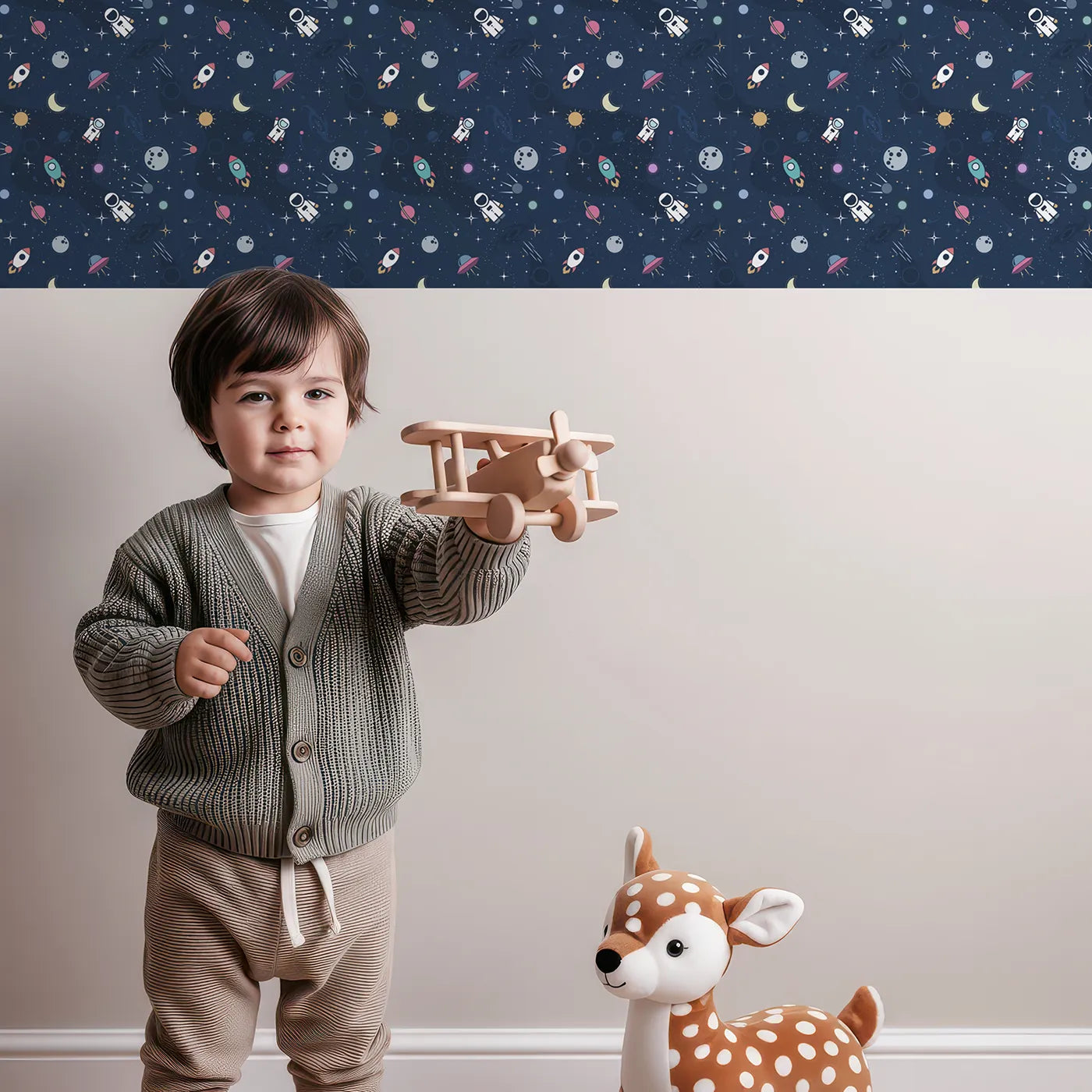 Lovely child standing in front of Whimsy Tots Flat Graphic Space Wallpaper with space, astronaut, rocket, planet, modern in design.
