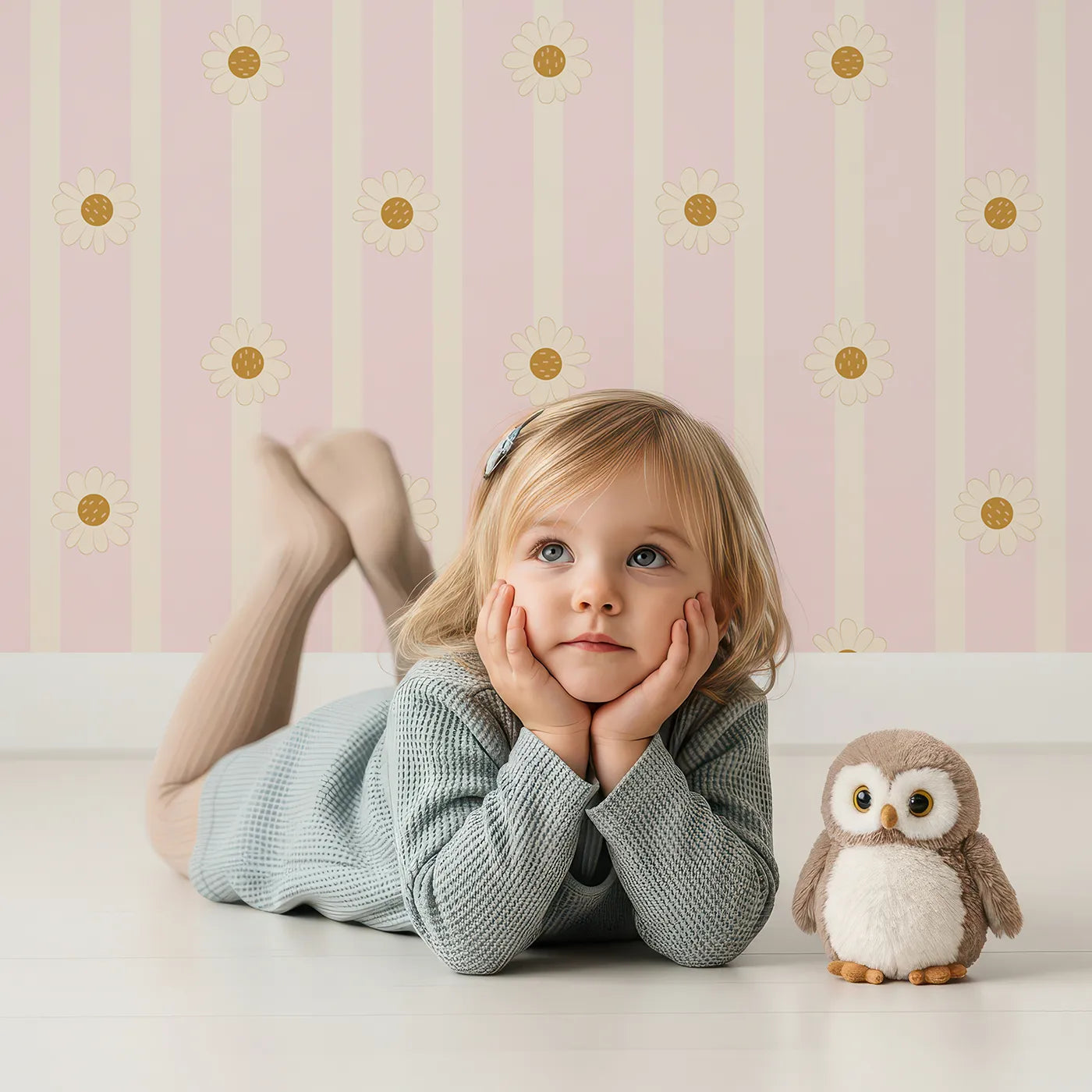 Lovely child standing in front of Whimsy Tots Daisy Lane Stripe Wallpaper in Pink with daisy, flower, stripe in design.