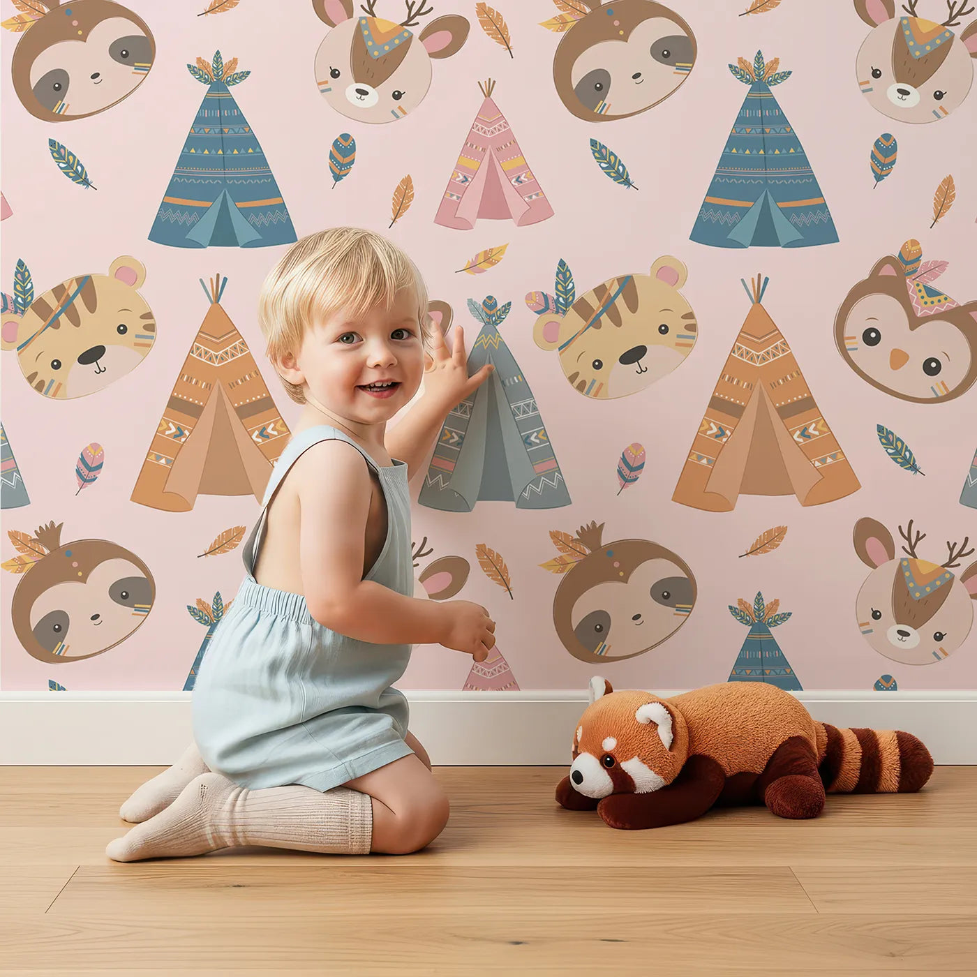 Lovely child standing in front of Whimsy Tots Tribal Pals Wallpaper in Pink with owl, sloth, deer, tiger, tent, feather in design.