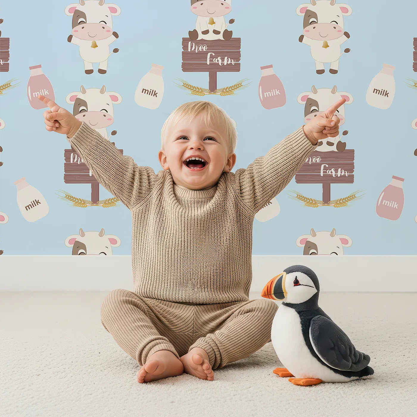 Lovely child standing in front of Whimsy Tots Moo Farm Friends Wallpaper in Blue with cow, bottle, bell, wheat, sign in design.