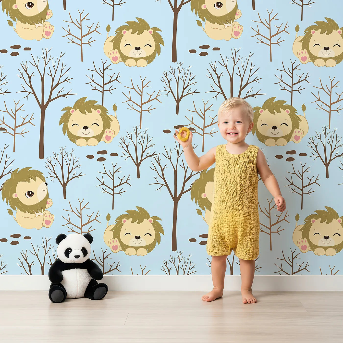 Lovely child standing in front of Whimsy Tots Little Lion Nap Wallpaper in Blue with lion, tree, footprint in design.