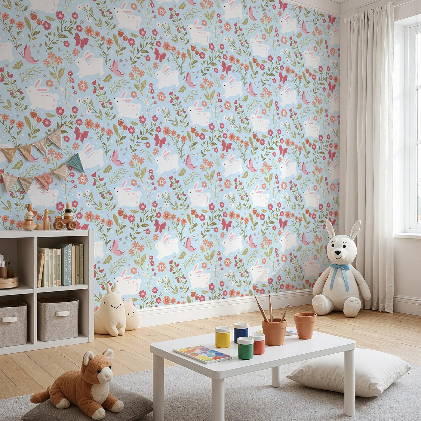 Angled view of Whimsy Tots' Meadow Hops Bunny Wallpaper in Blue (W3047D).Joyful bunnies leap through blossoms and butterflies under soft blue skies.