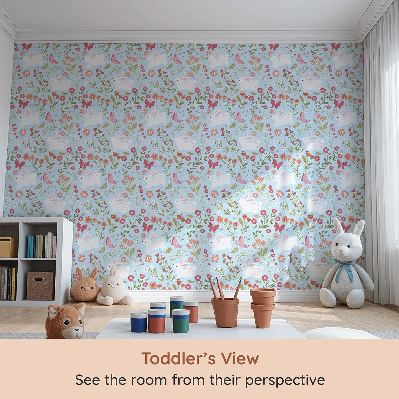 Whimsy Tots Meadow Hops Bunny Wallpaper in Blue (W3047D) from your child's view.Joyful bunnies leap through blossoms and butterflies under soft blue skies.