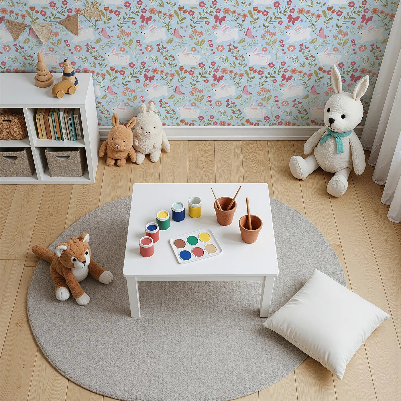 Top-Down view of Whimsy Tots' Meadow Hops Bunny Wallpaper in Blue (W3047D).Joyful bunnies leap through blossoms and butterflies under soft blue skies.