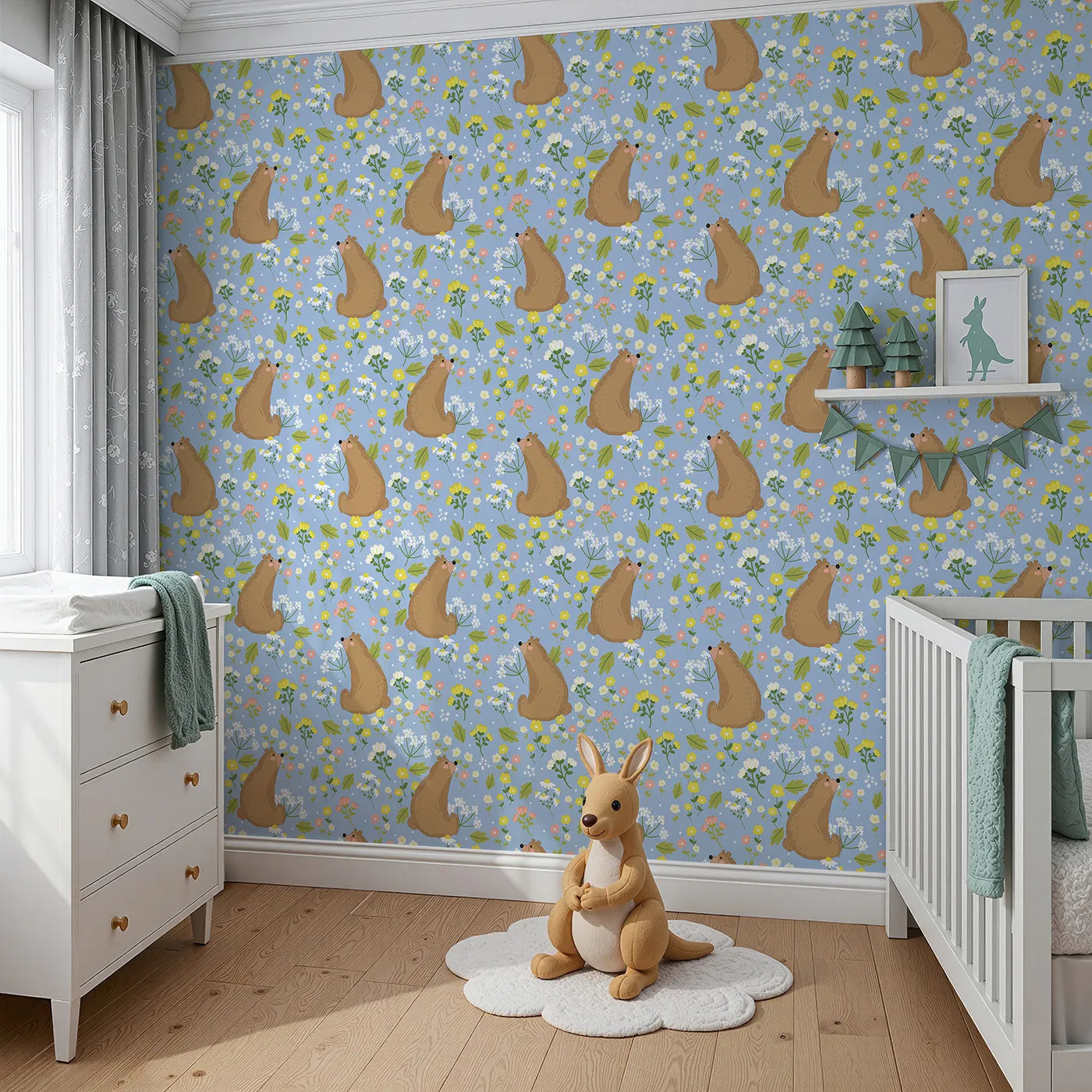 Angled view of Whimsy Tots' Blossom Bear Meadow Wallpaper in Bluebell Sky (W3062D).Playful brown bears sniff blossoms beneath a cheery blue sky.