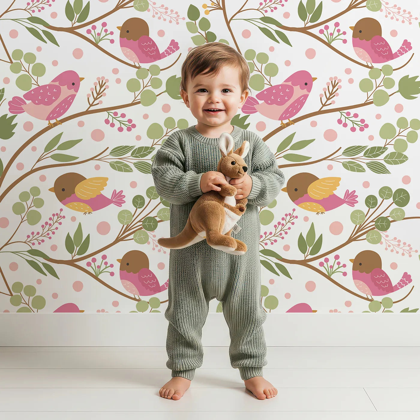 Lovely child standing in front of Whimsy Tots Blossom Branch Birds Wallpaper in White with bird, leaf, berry, branch in design.