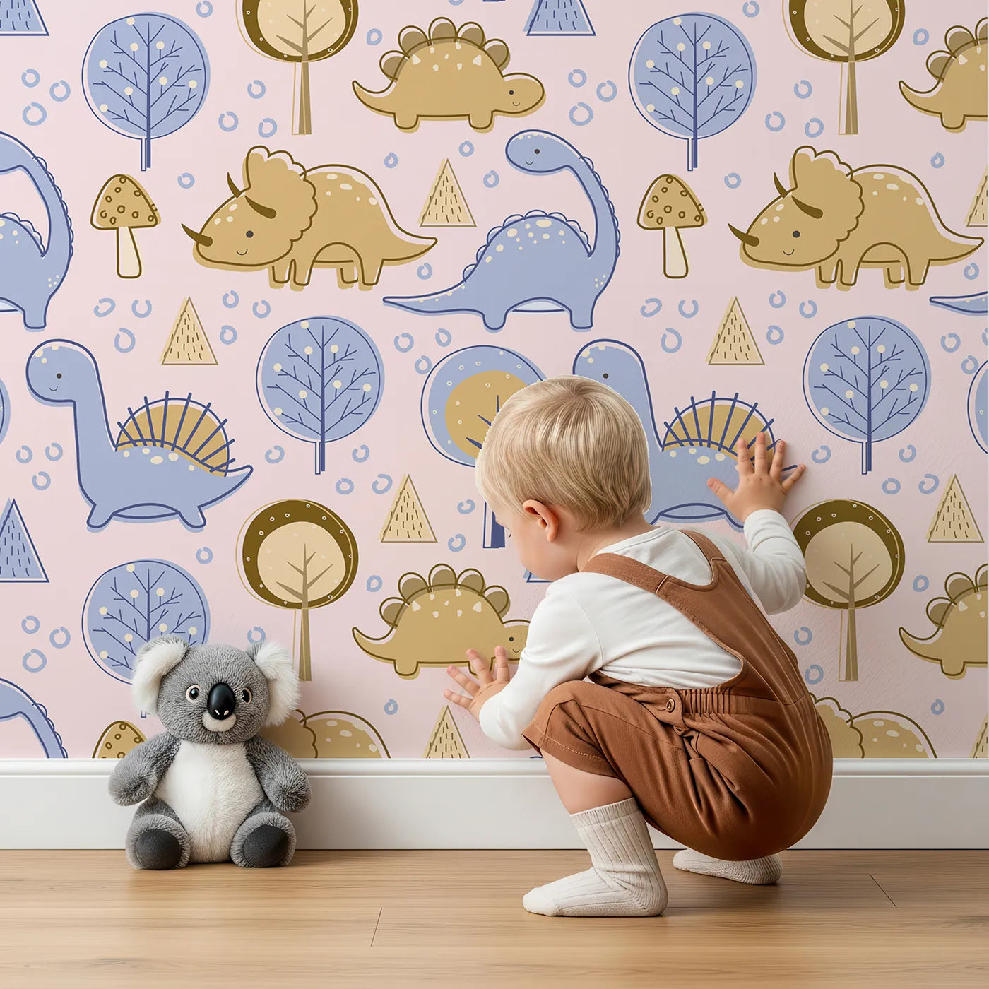 Lovely child standing in front of Whimsy Tots Jurassic Forest Friends Wallpaper in Blush Pink with dinosaur, tree, triangle, dino, forest in design.