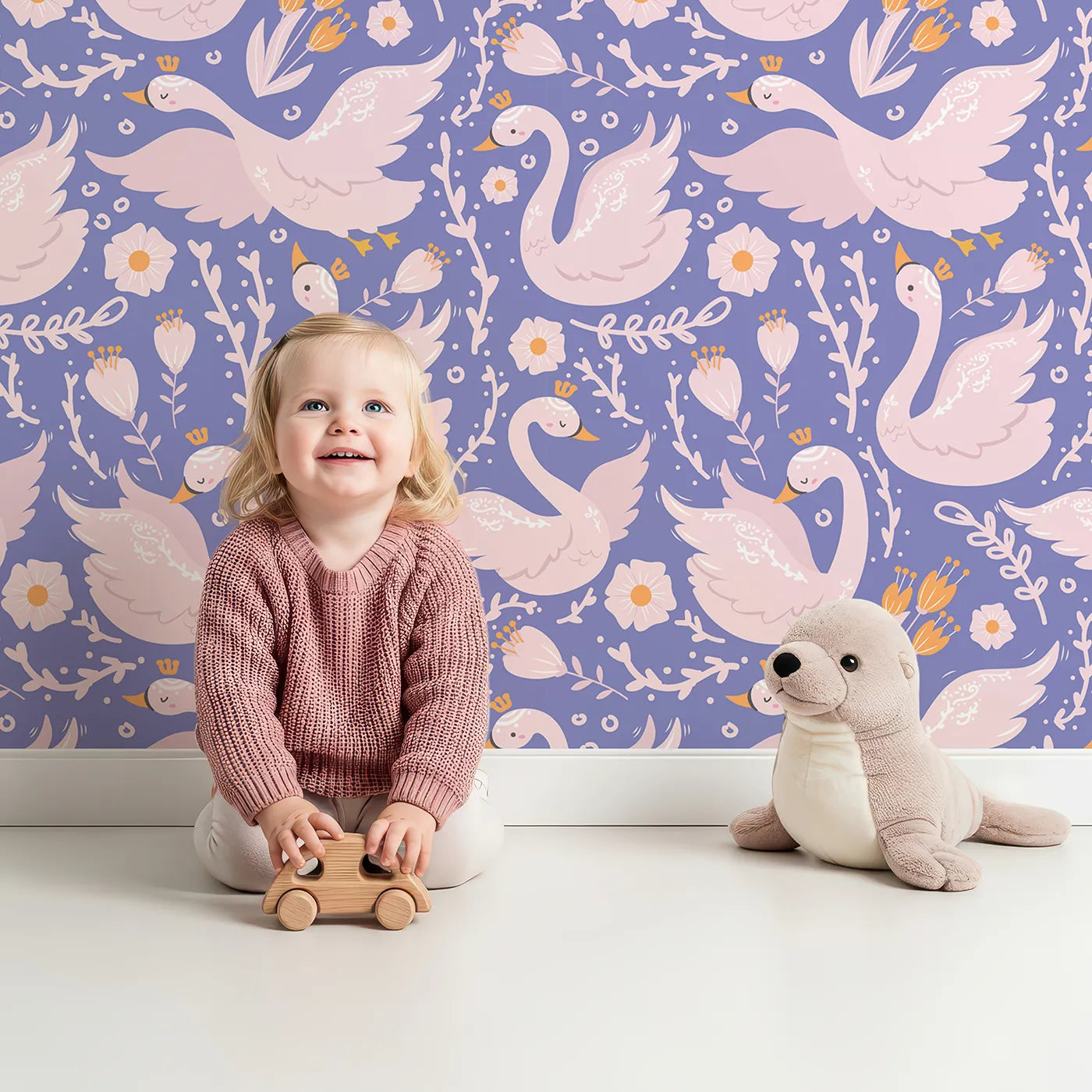 Lovely child standing in front of Whimsy Tots Starlit Swan Ballet Wallpaper in Periwinkle Purple with swan, crown, flower, bow, leaf in design.