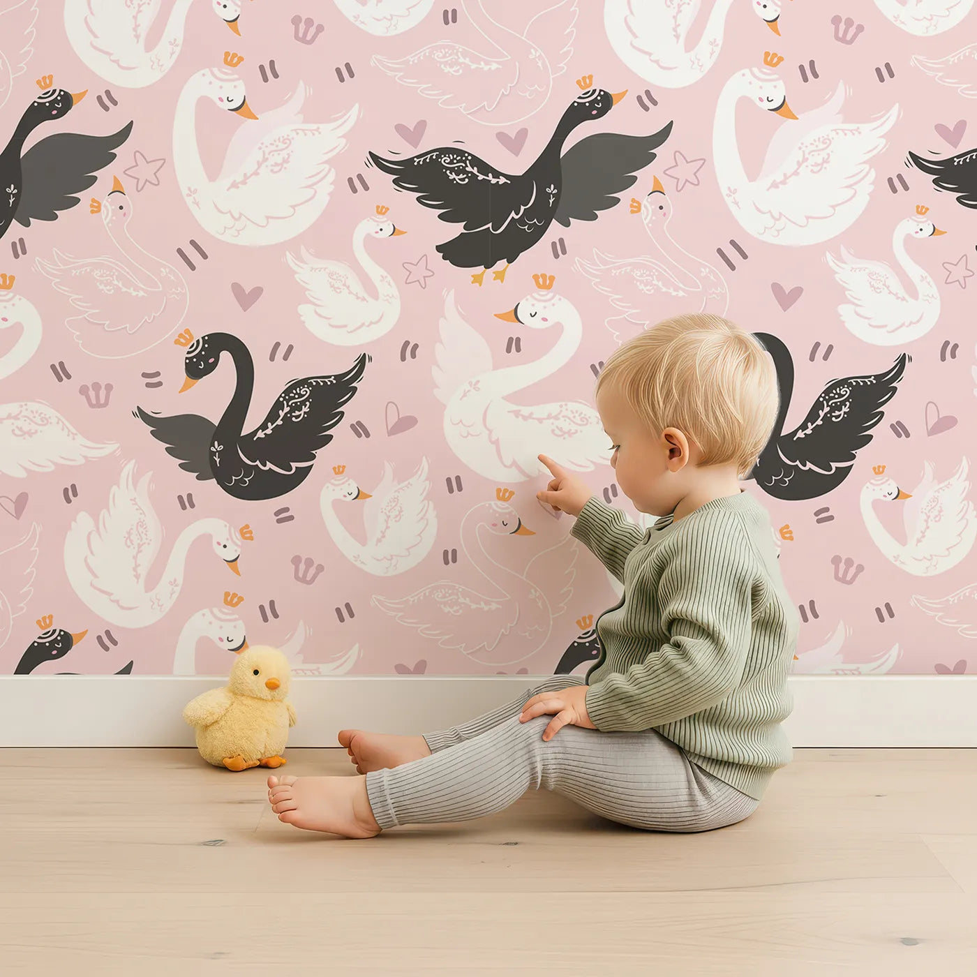 Lovely child standing in front of Whimsy Tots Royal Swan Parade Wallpaper in Pink with swan, crown, heart, star, wing in design.