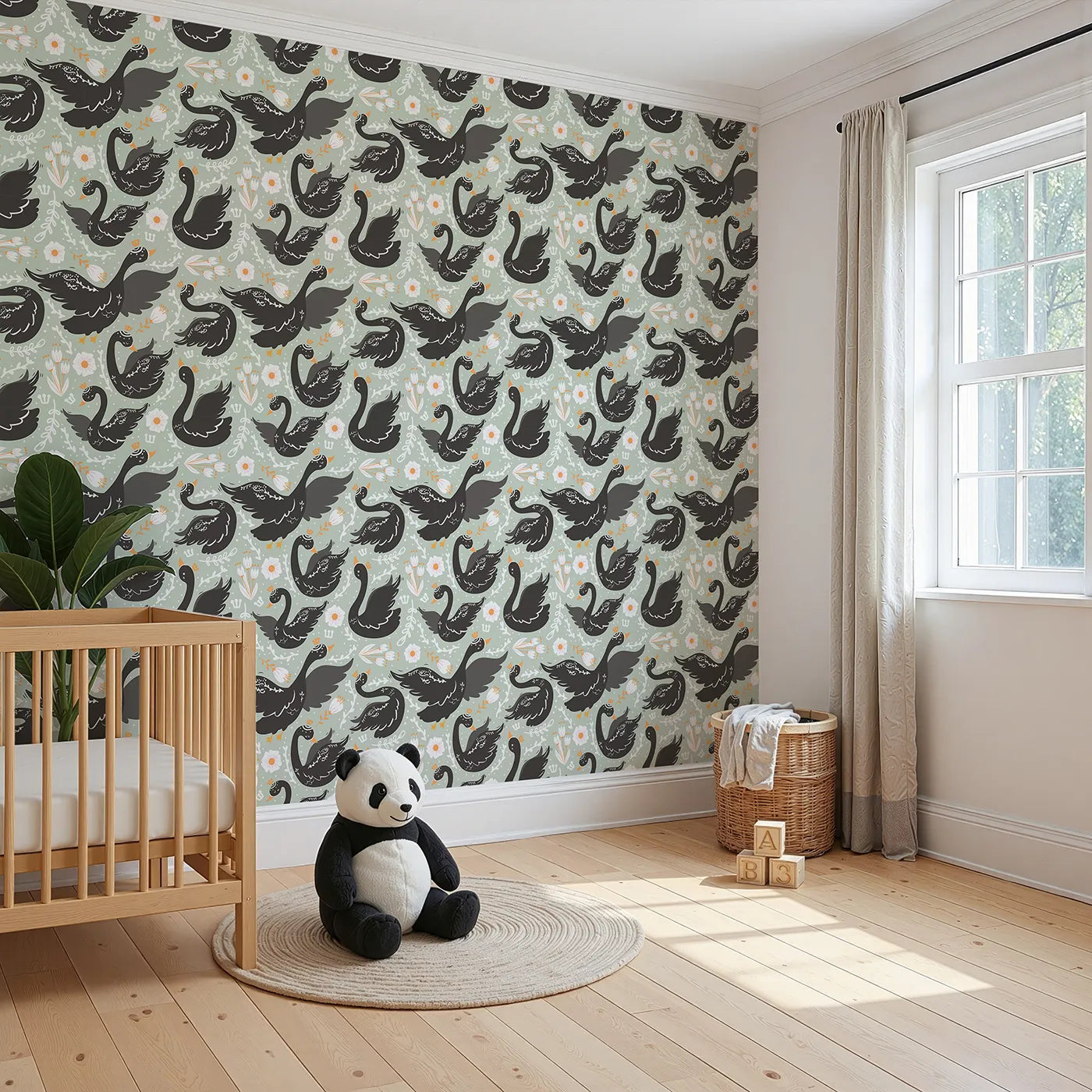 Angled view of Whimsy Tots' Regal Swan Parade Wallpaper in Sage Green (W3087D).Black swans with tiny crowns drift among flowers on a soft green breeze.