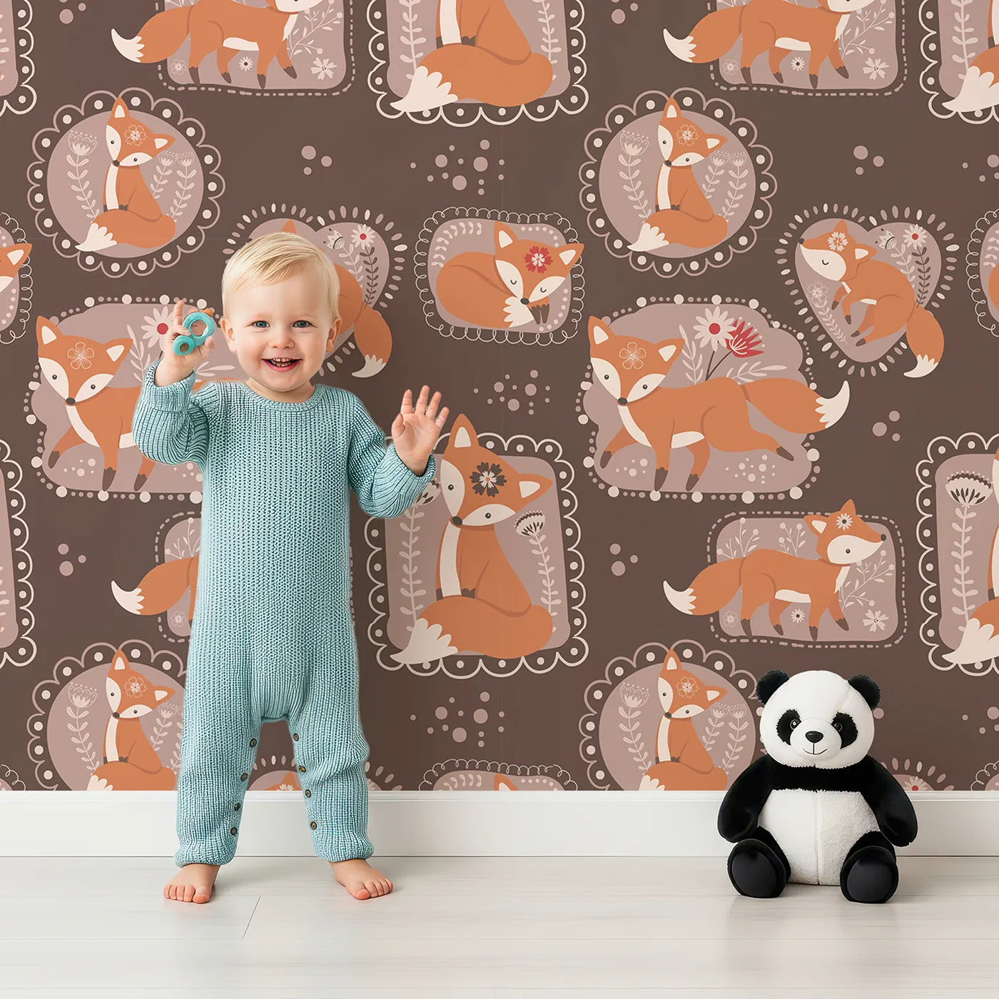 Lovely child standing in front of Whimsy Tots Fox Meadow Moments Wallpaper in Cocoa Brown with fox, flower, frame in design.