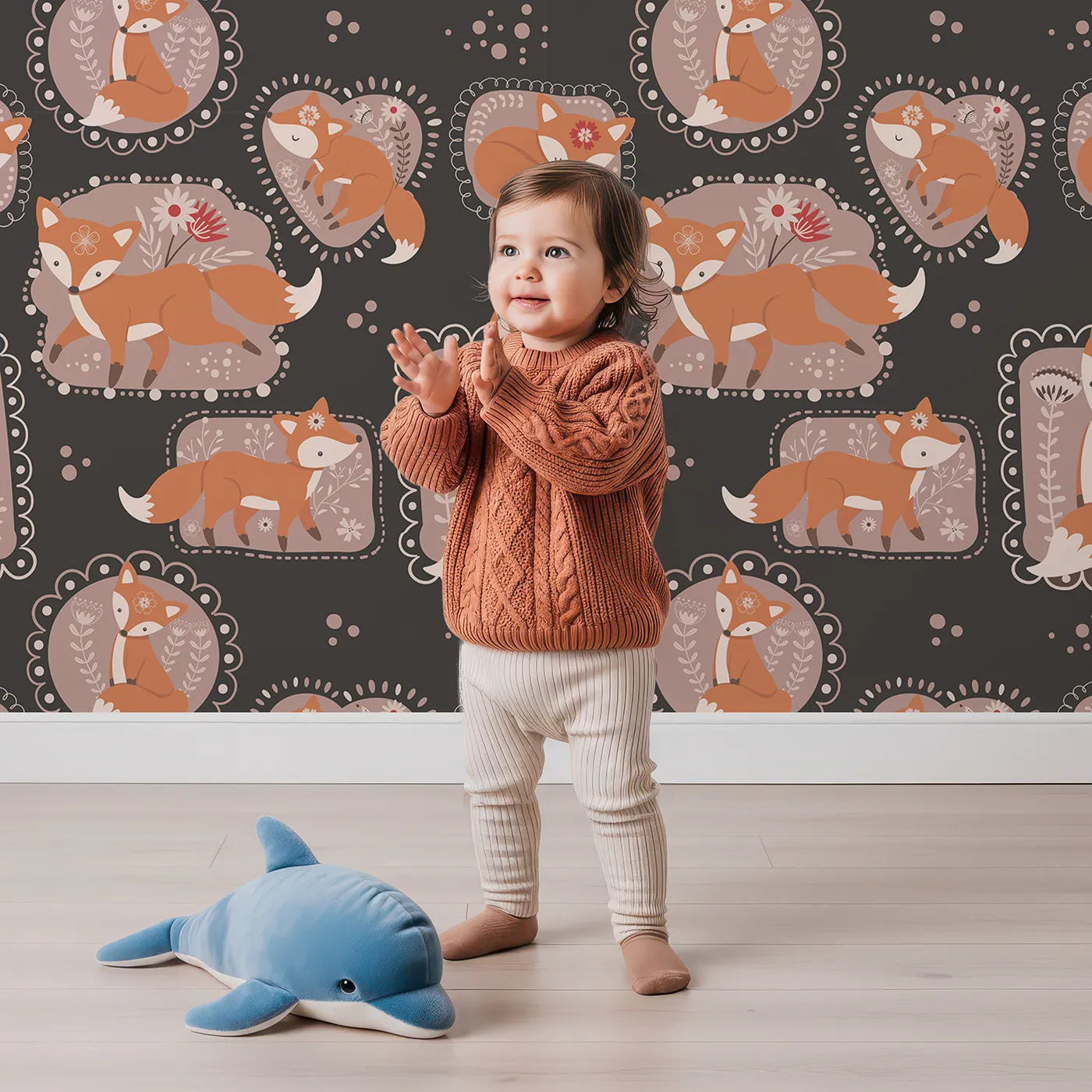 Lovely child standing in front of Whimsy Tots Fox Meadow Moments Wallpaper in Charcoal Gray with fox, flower, frame in design.