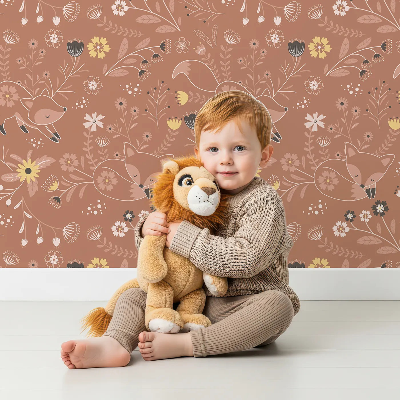 Lovely child standing in front of Whimsy Tots Wildflower Fox Dreams Wallpaper in Terracotta with fox, flower, vine in design.