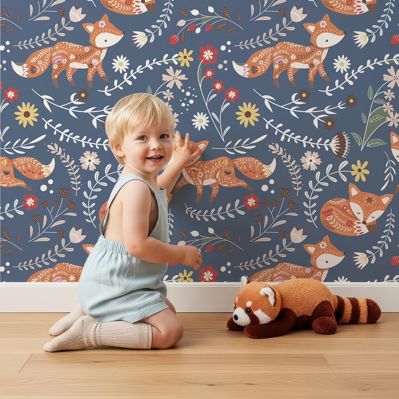 Lovely child standing in front of Whimsy Tots Folk Bloom Foxes Wallpaper in Twilight Blue with fox, flower, vine in design.