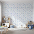 Front view of Whimsy Tots' Dino Fossil Footprints Wallpaper in Sky Blue