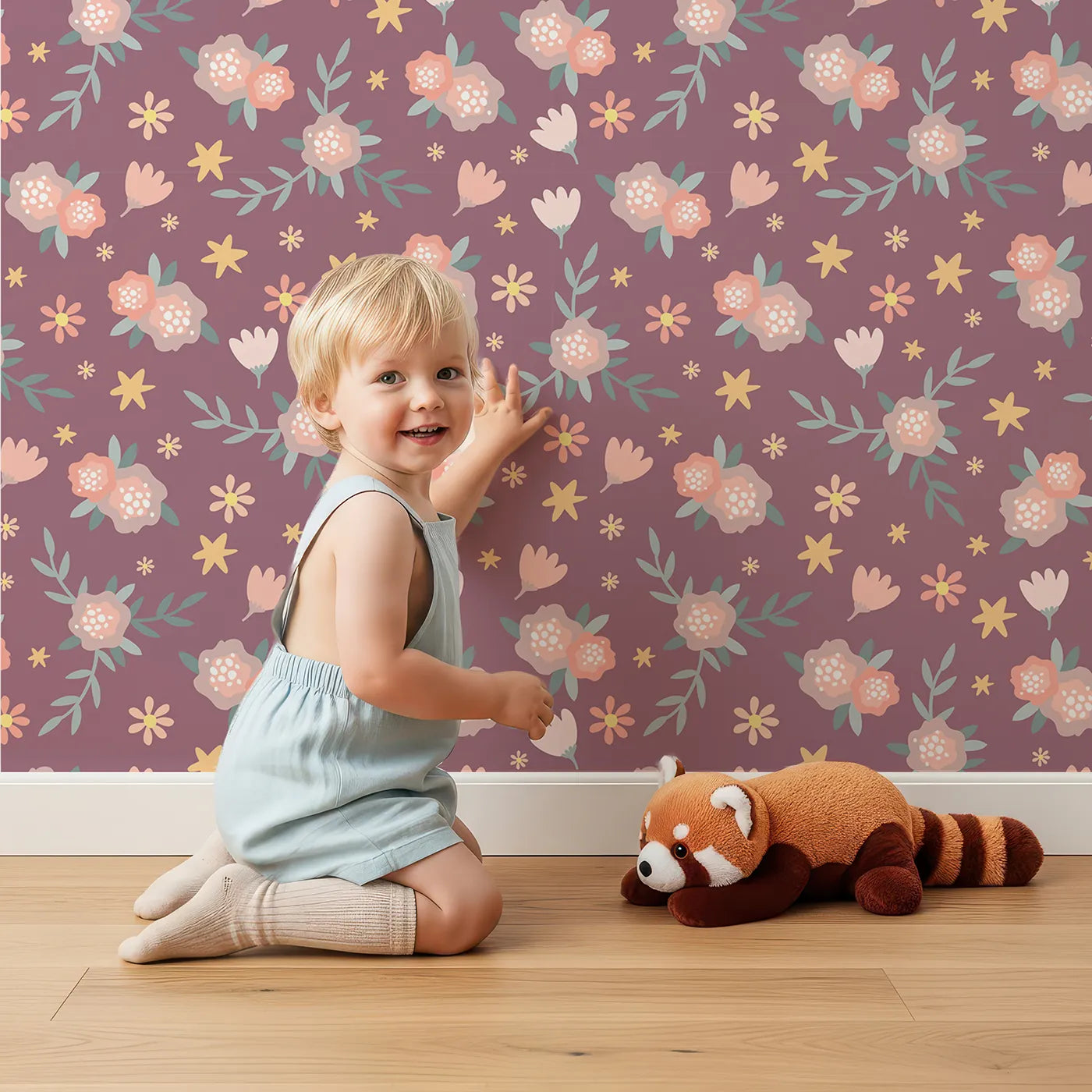 Lovely child standing in front of Whimsy Tots Twilight Garden Whimsy Wallpaper in Plum Blush Pink with flower, leaf, star, bloom in design.