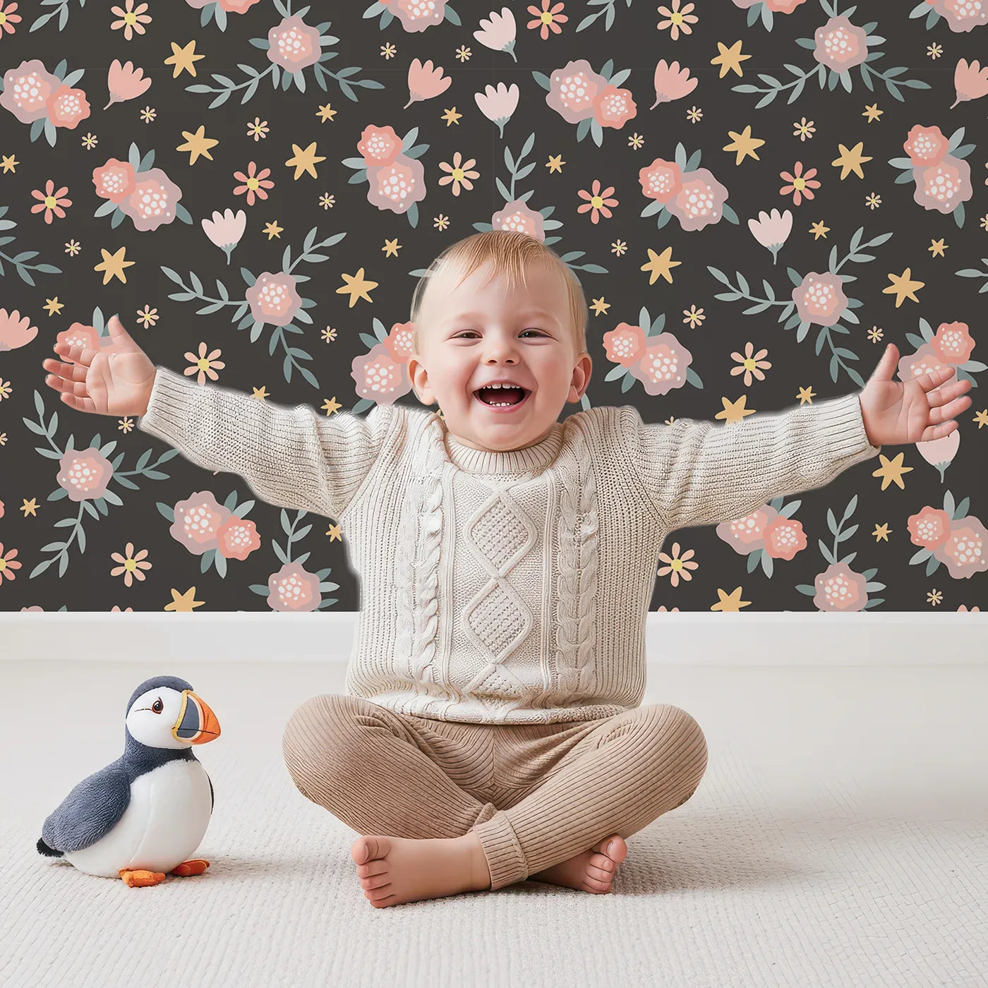 Lovely child standing in front of Whimsy Tots Twilight Garden Whimsy Wallpaper in Midnight Petal with flower, leaf, star, bloom in design.
