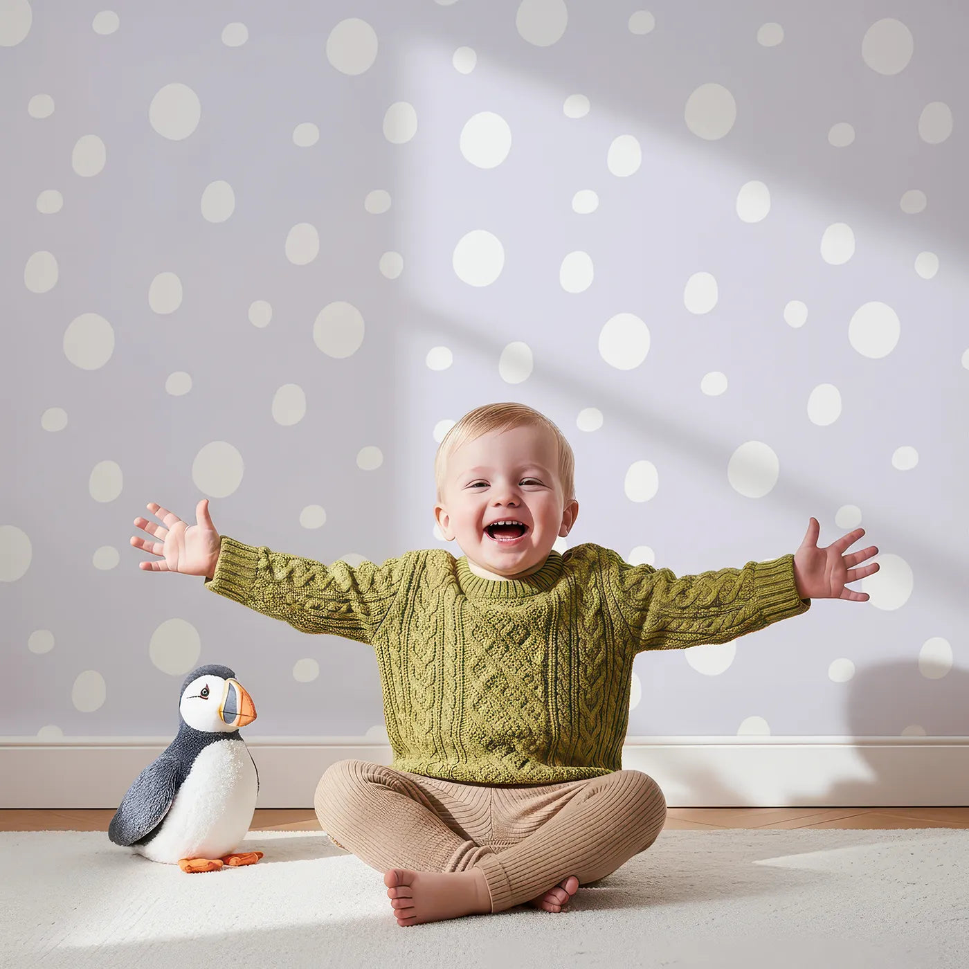Lovely child standing in front of Whimsy Tots Gentle Pebble Dots Wallpaper in Lavender Haze with dot, spot, pebble, lavender in design.