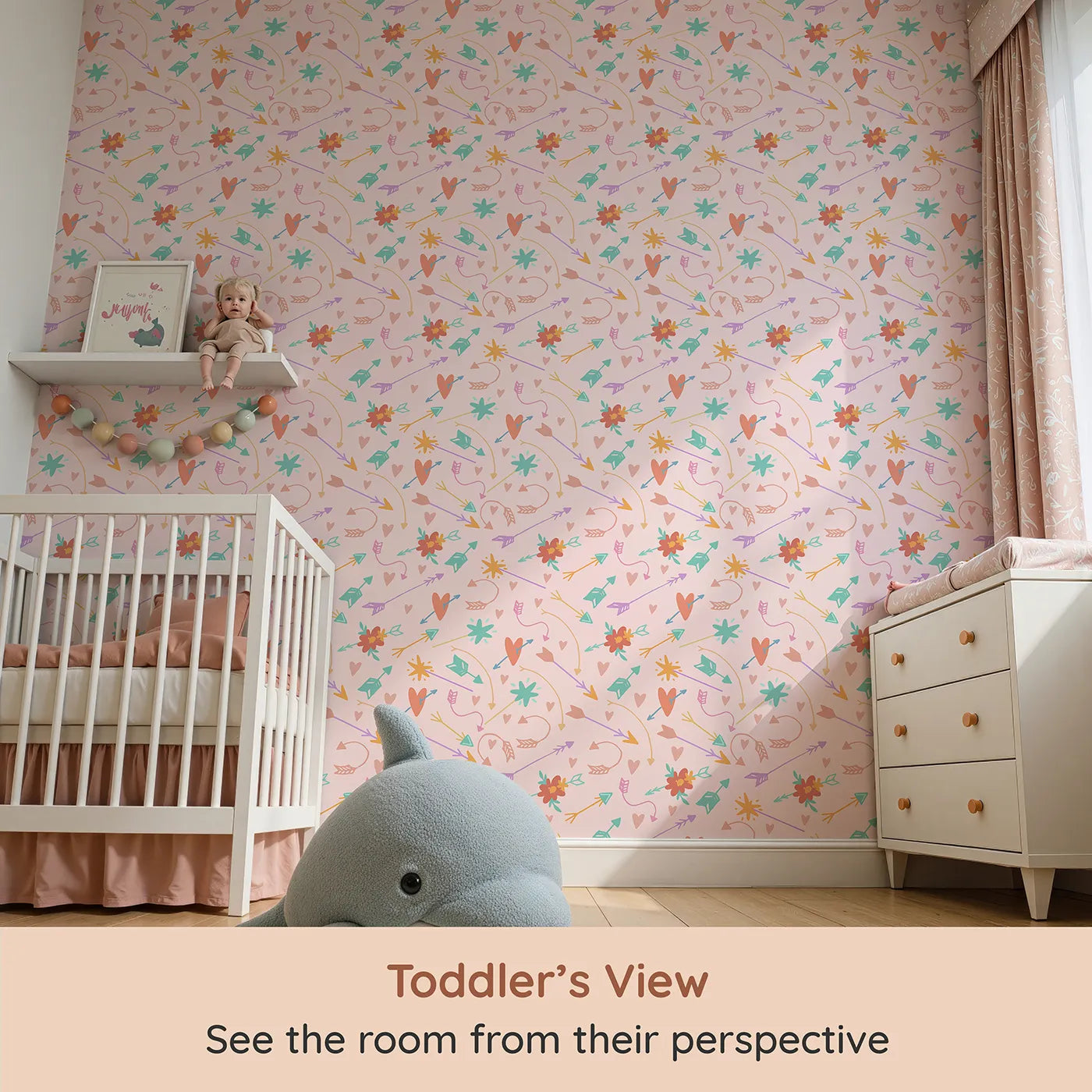 Whimsy Tots Love and Arrows Bloom Parade Wallpaper in Blush Pink (W3145B) from your child's view.Hearts and blossoms flutter across a candy-pink sky.