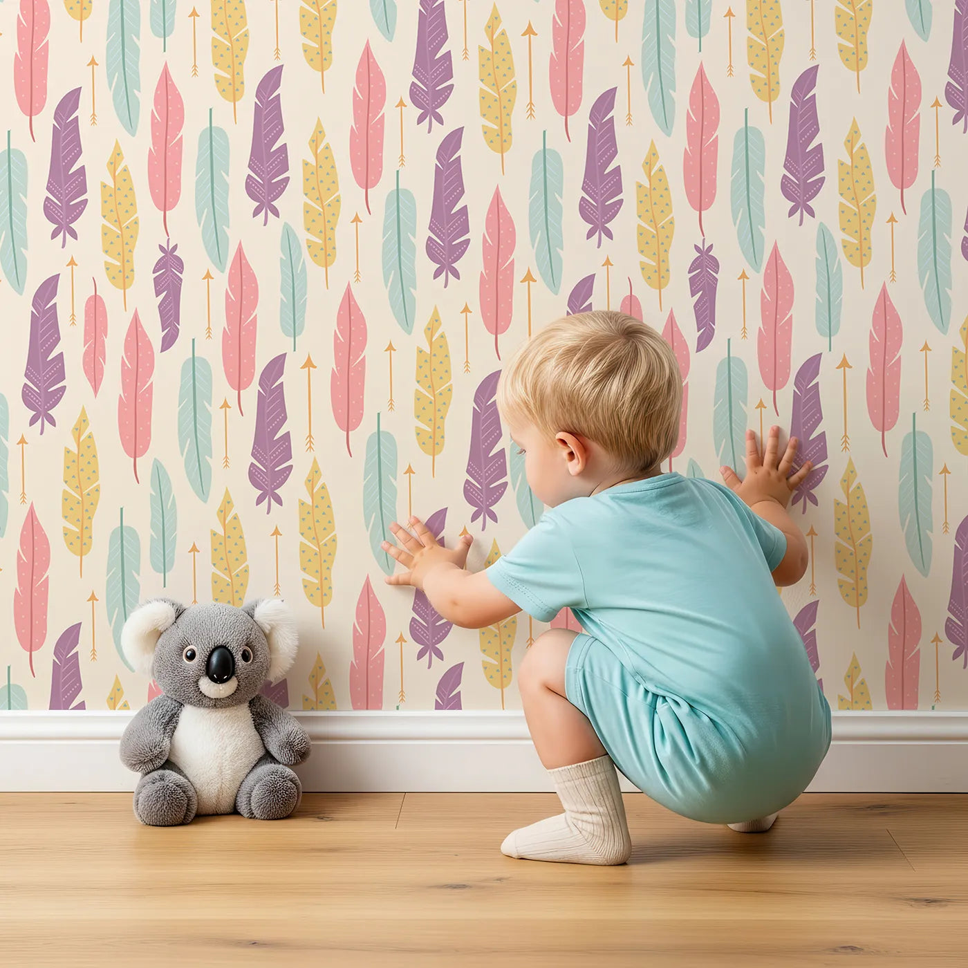 Lovely child standing in front of Whimsy Tots Feather and Arrow Meadow Parade Wallpaper in Vanilla Cream with feather, arrow, leaf in design.