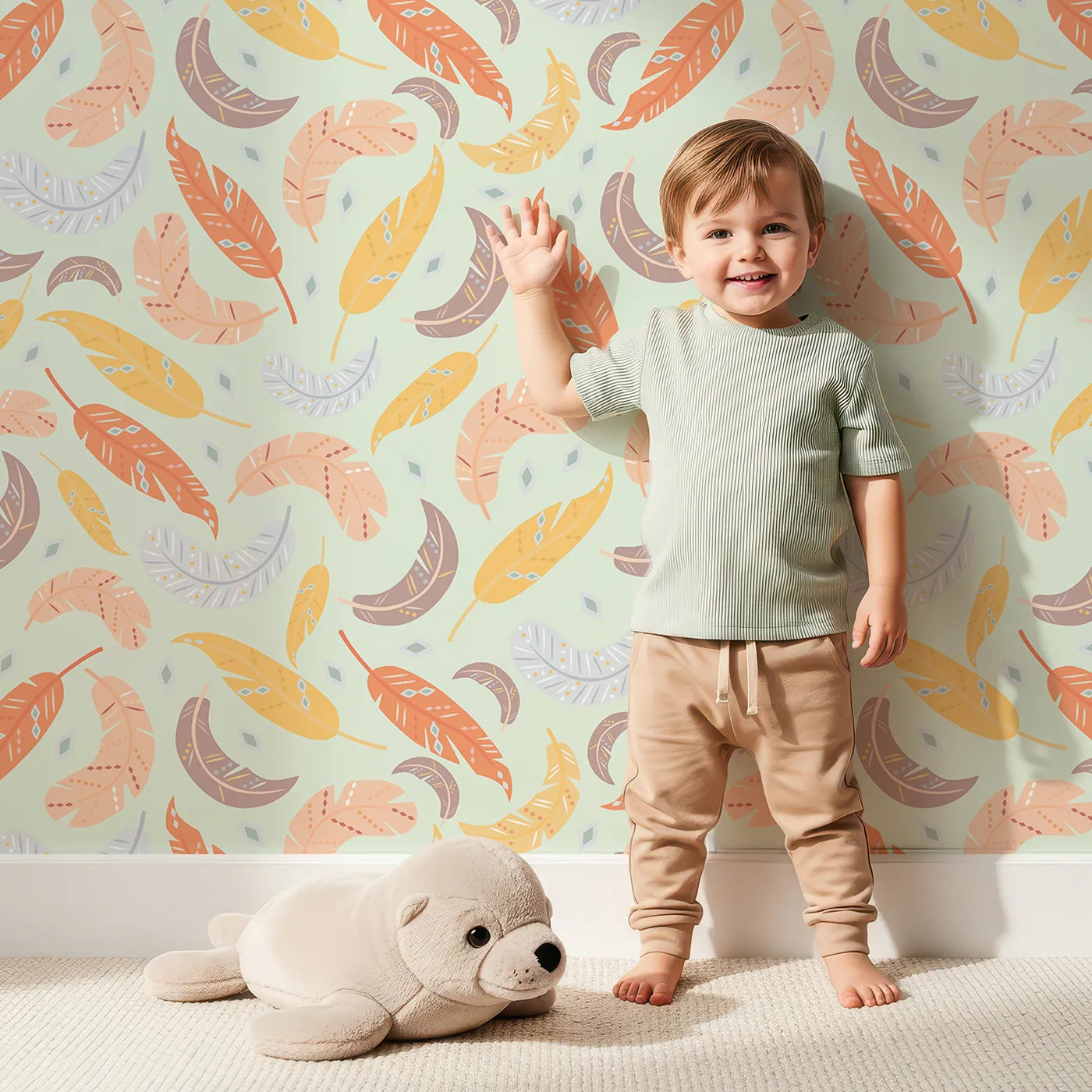 Lovely child standing in front of Whimsy Tots Feathered Whimsy Drift Wallpaper in Sage Mist with feather, diamond, dot in design.