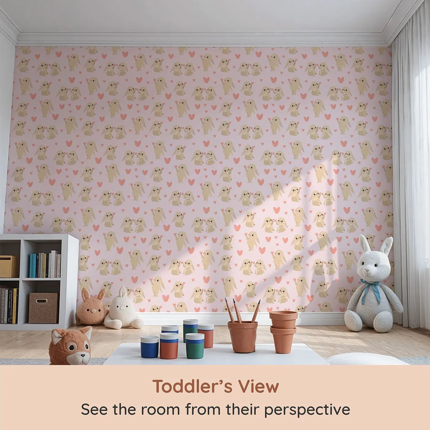 Whimsy Tots Heartful Bunny Parade Wallpaper in Blush Pink (W3159B) from your child's view.Lovable bunnies hold pink hearts across a gentle blush sky.