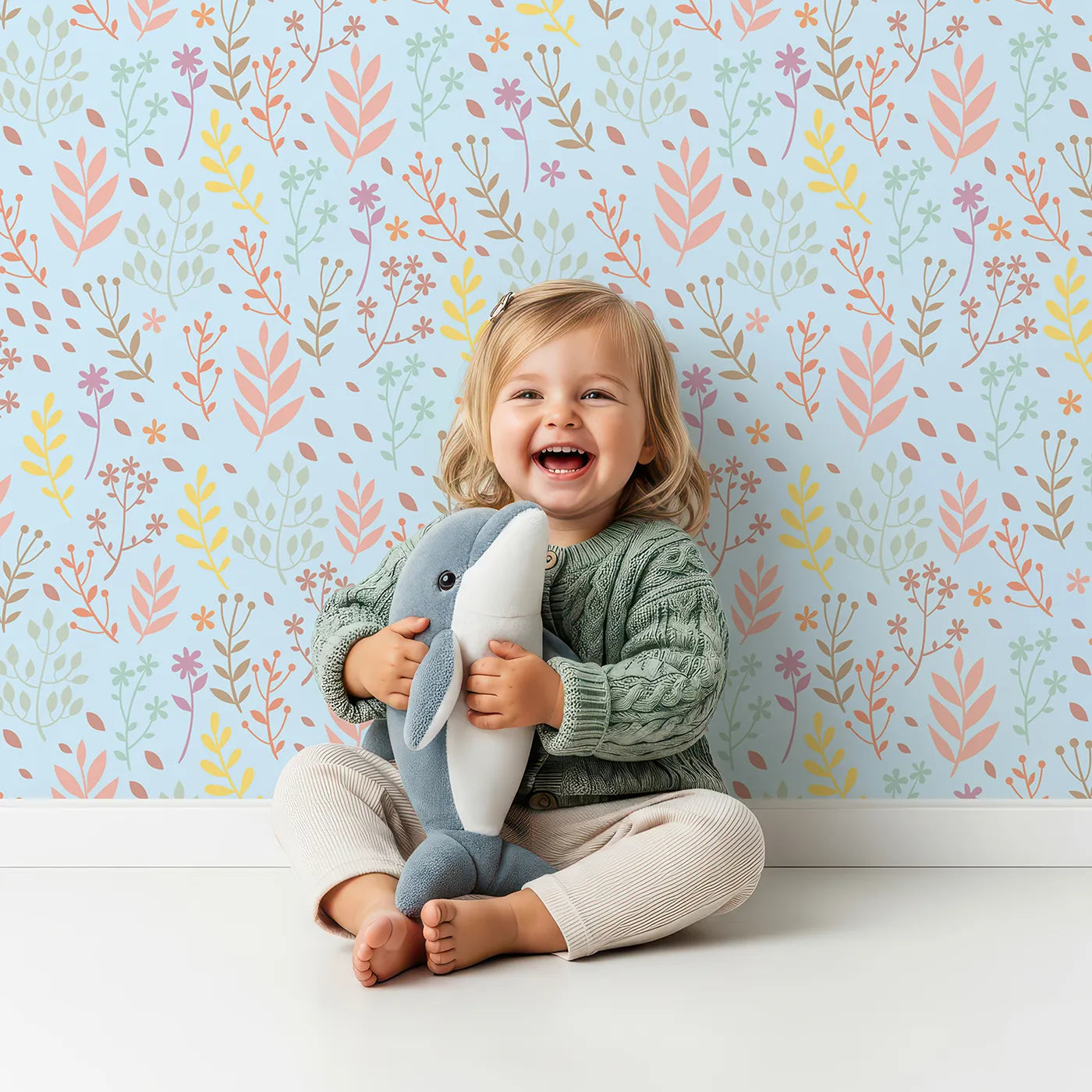 Lovely child standing in front of Whimsy Tots Whimsy Meadow Sketch Wallpaper in Sky with leaf, flower, branch in design.
