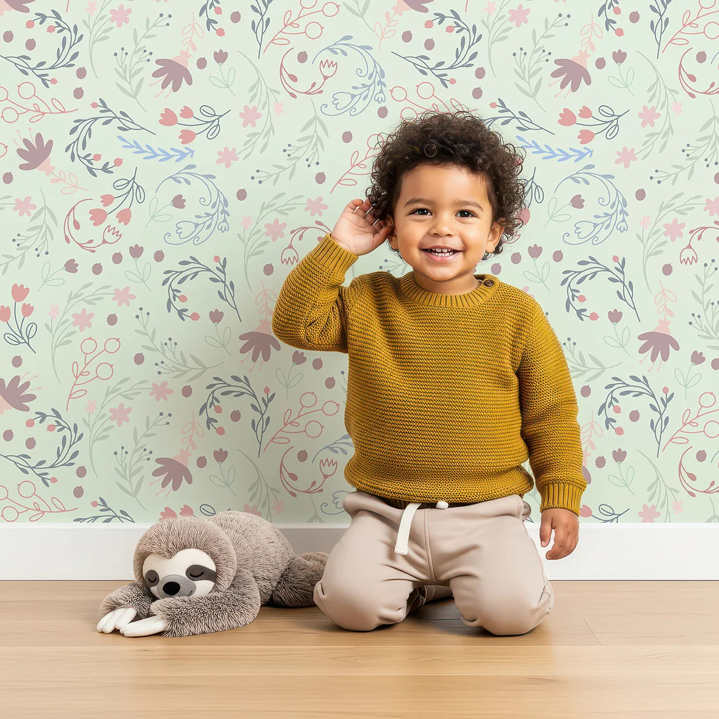 Lovely child standing in front of Whimsy Tots Fairy Petal Garden Wallpaper in Mint Green with fairy, flower, leaf, berry in design.
