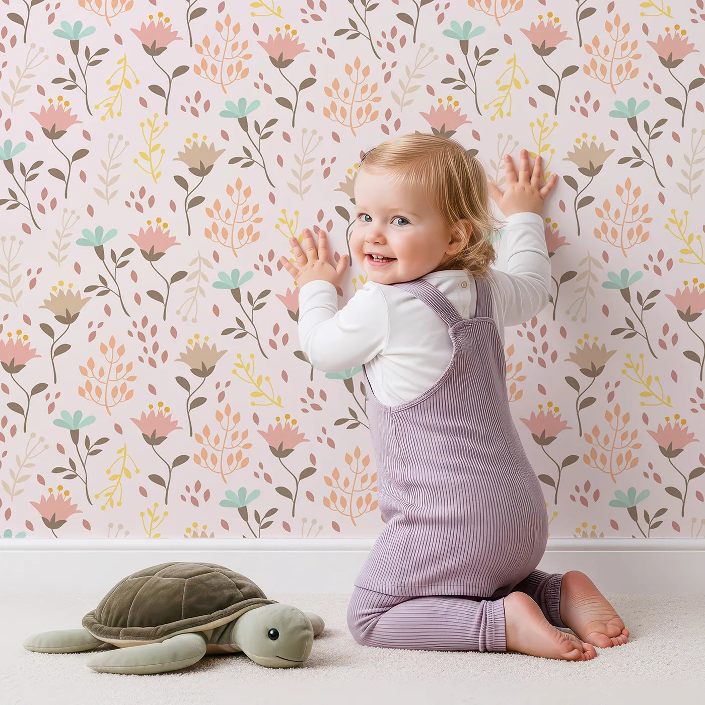 Lovely child standing in front of Whimsy Tots Blooming Meadow Stems Wallpaper in Blush Pink with flower, leaf, wildflower, stem in design.