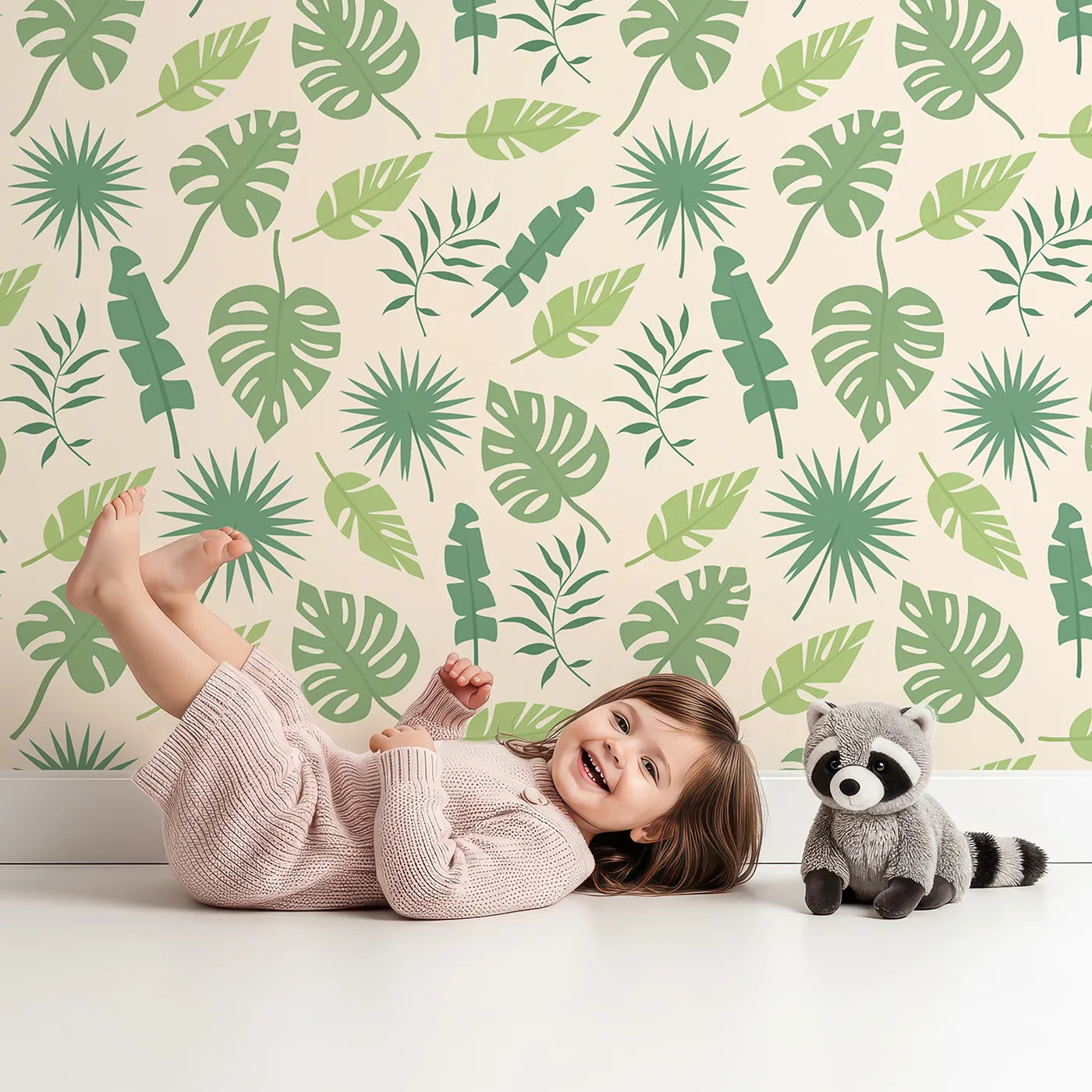 Lovely child standing in front of Whimsy Tots Tropical Leaf Mix Wallpaper in Cream with leaf, monstera, palm, jungle in design.