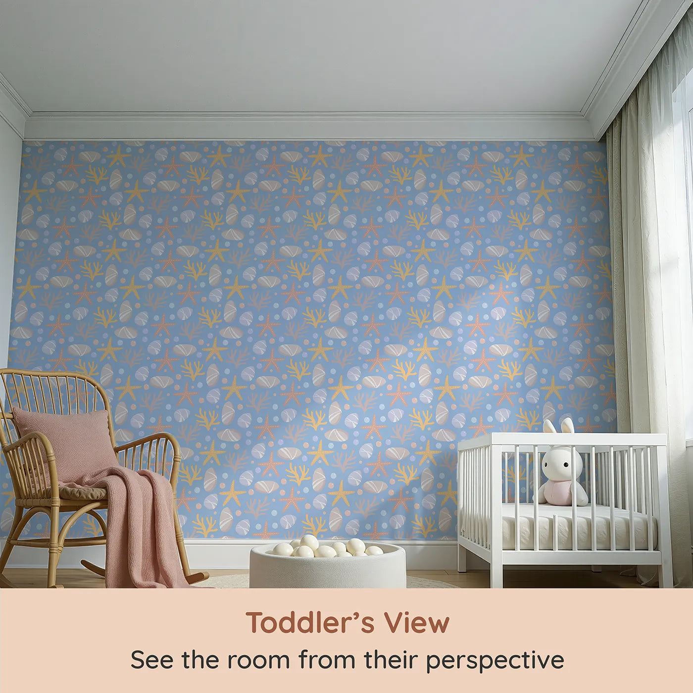 Whimsy Tots Pebble Shoreline Calm Wallpaper in Sky Blue (W3192B) from your child's view.Gentle stones, starfish, and coral float across a quiet seaside breeze.
