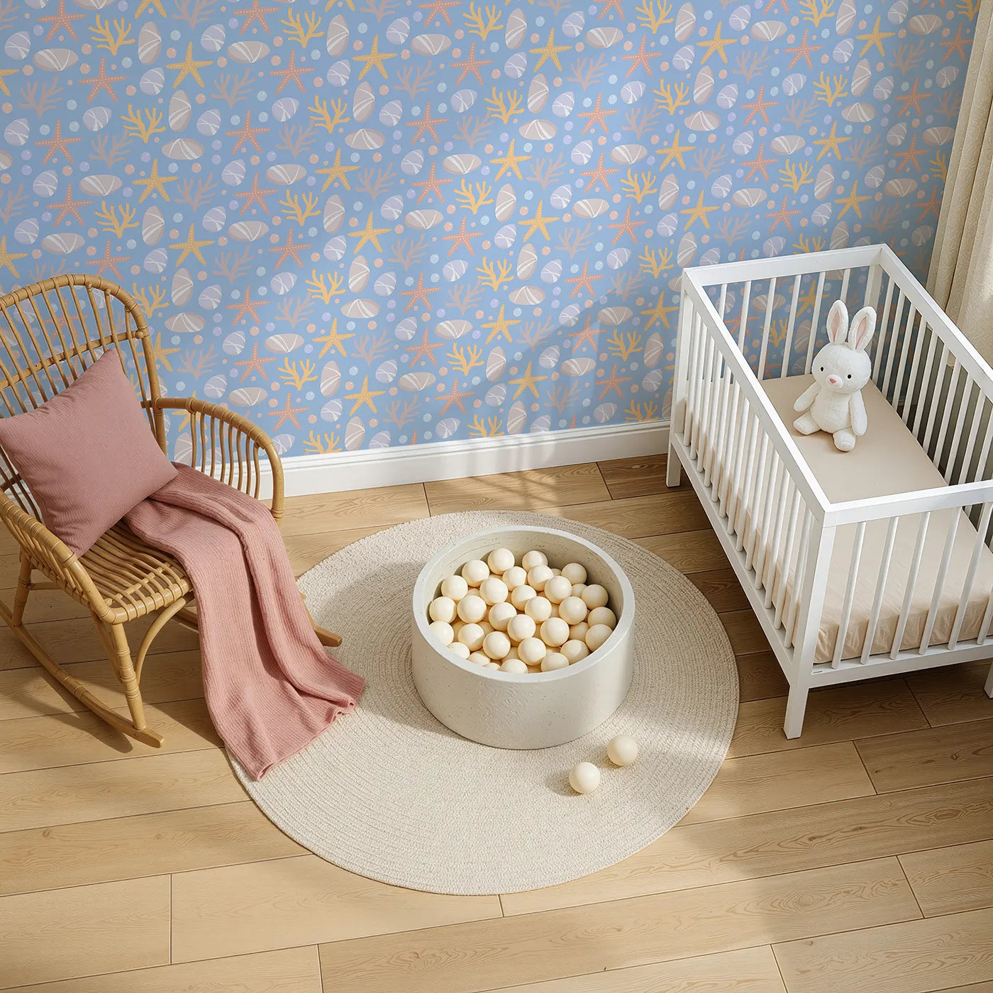 Top-Down view of Whimsy Tots' Pebble Shoreline Calm Wallpaper in Sky Blue (W3192B).Gentle stones, starfish, and coral float across a quiet seaside breeze.