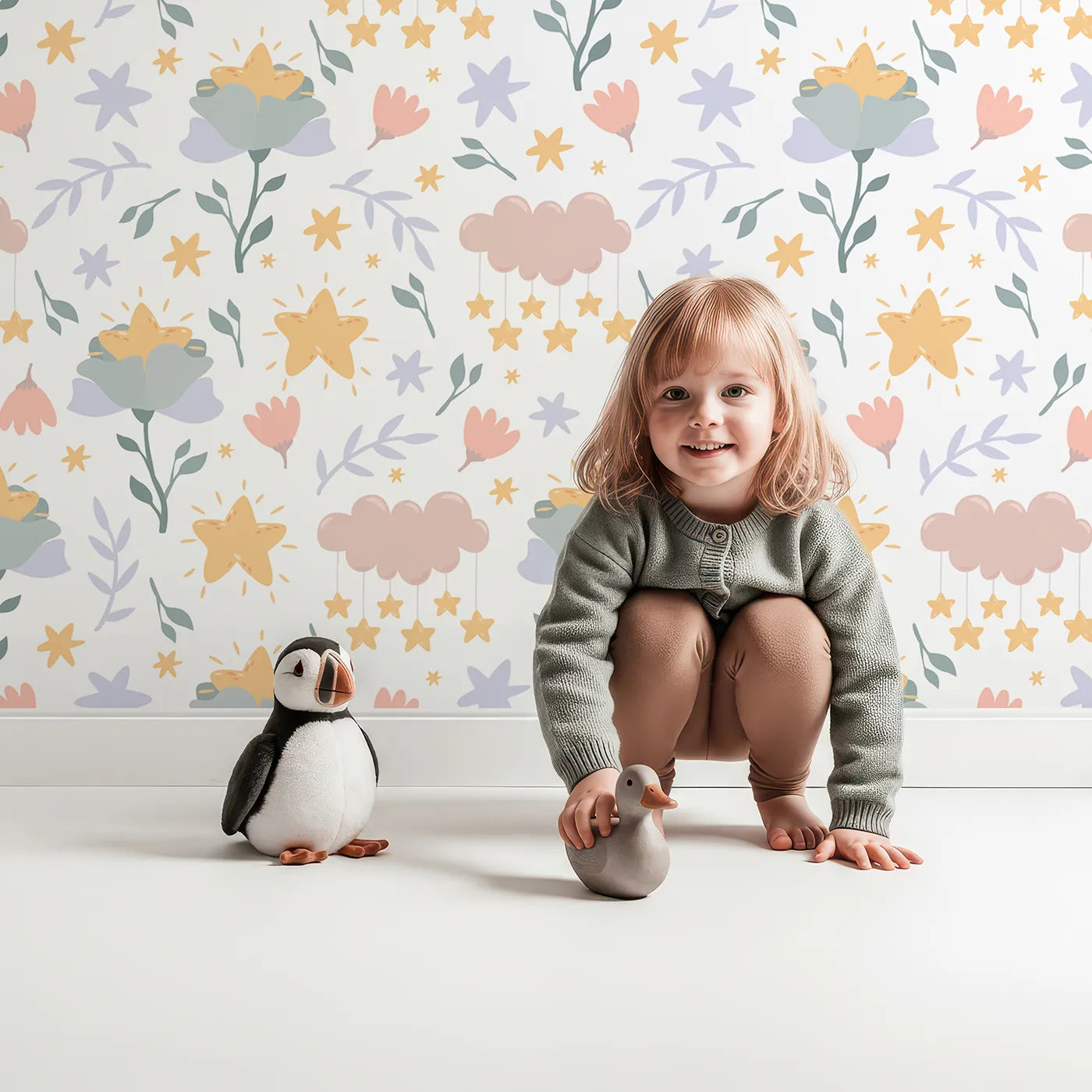 Lovely child standing in front of Whimsy Tots Starlight Blossom Dreams Wallpaper in White with star, flower, cloud, leaf in design.