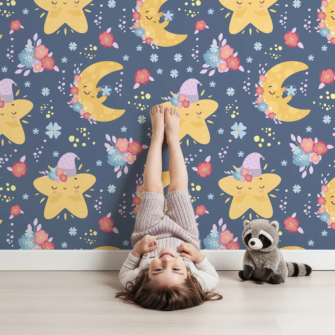 Lovely child standing in front of Whimsy Tots Starry Cuddle Sky Wallpaper in Midnight Blue with star, moon, flower, hat in design.