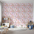 Front view of Whimsy Tots' Tiny Tots Toy Parade Wallpaper in Blush Pink