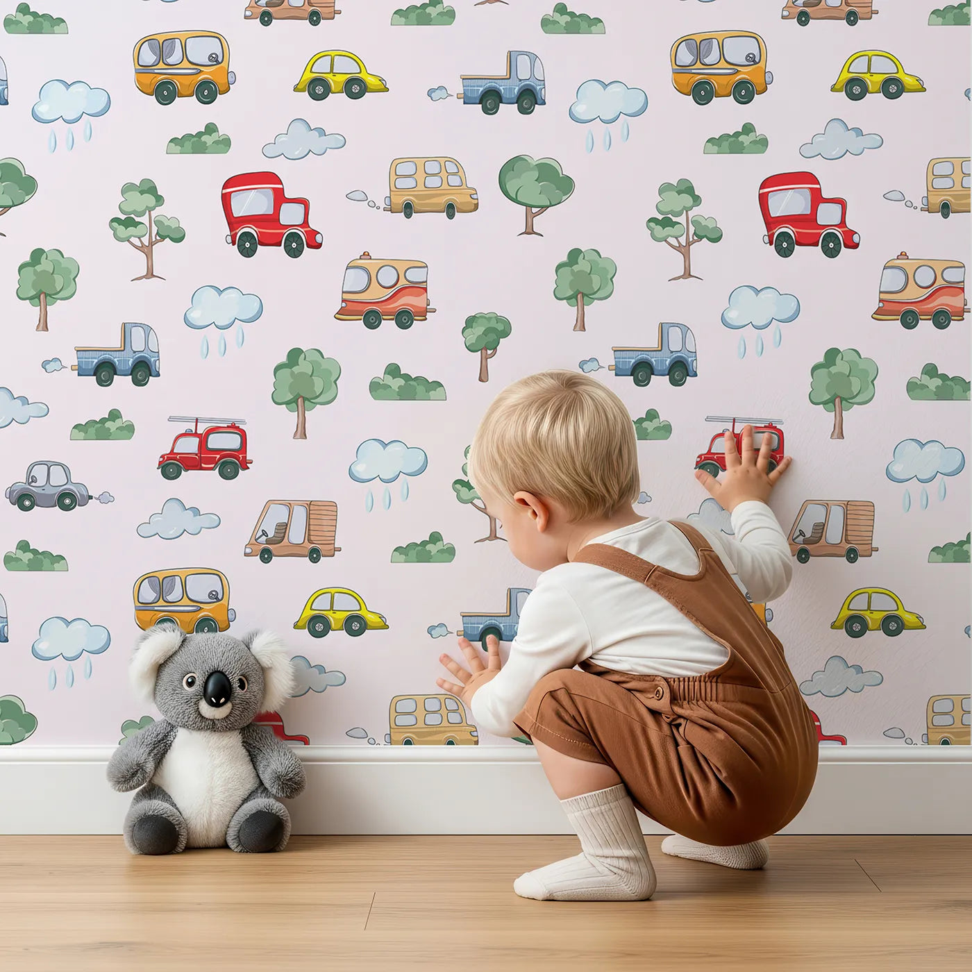 Lovely child standing in front of Whimsy Tots Bumper Buddies Forest Drive Wallpaper in Soft Pink with car, tree, cloud, raindrop, bus in design.