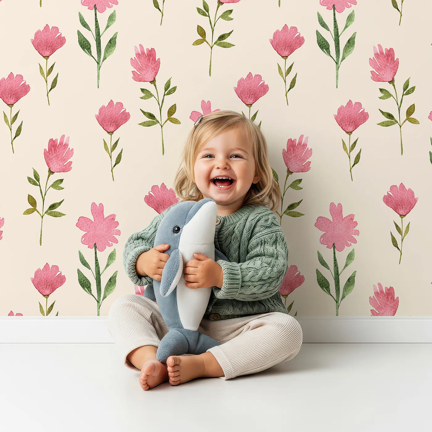 Lovely child standing in front of Whimsy Tots Pink Meadow Blossoms Wallpaper in Cream with flower, leaf in design.