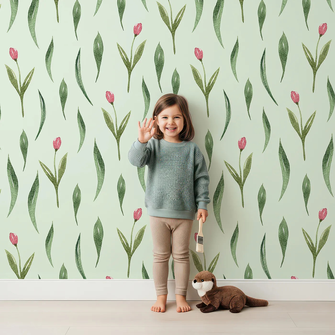 Lovely child standing in front of Whimsy Tots Tulip Meadow Dots Wallpaper in Mint Green with flower, leaf, tulip in design.